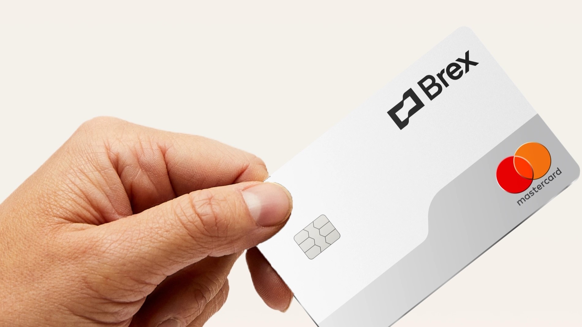 Hand holding white Brex card Hand holding white Brex card