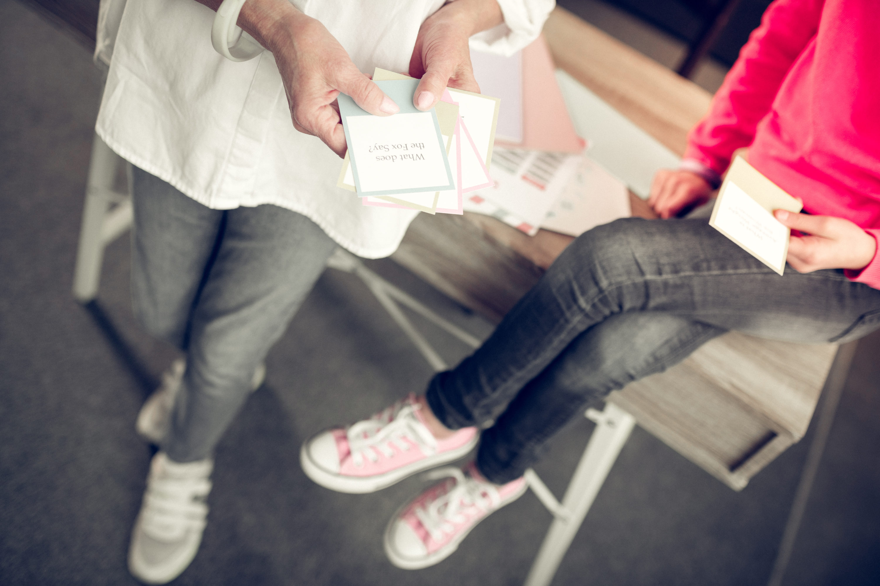 Adult and child looking at flashcards