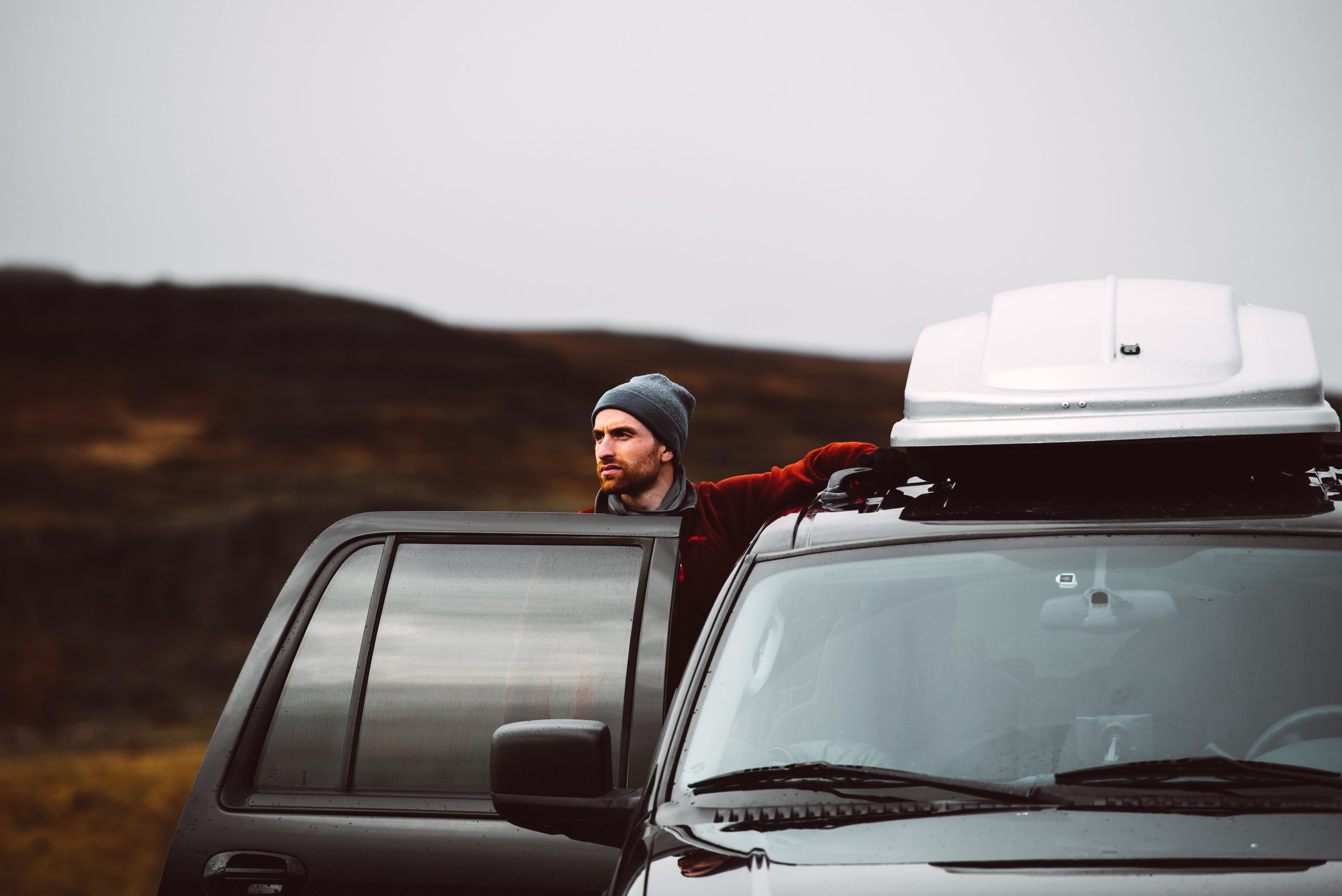 Man standing next to car Man standing next to car