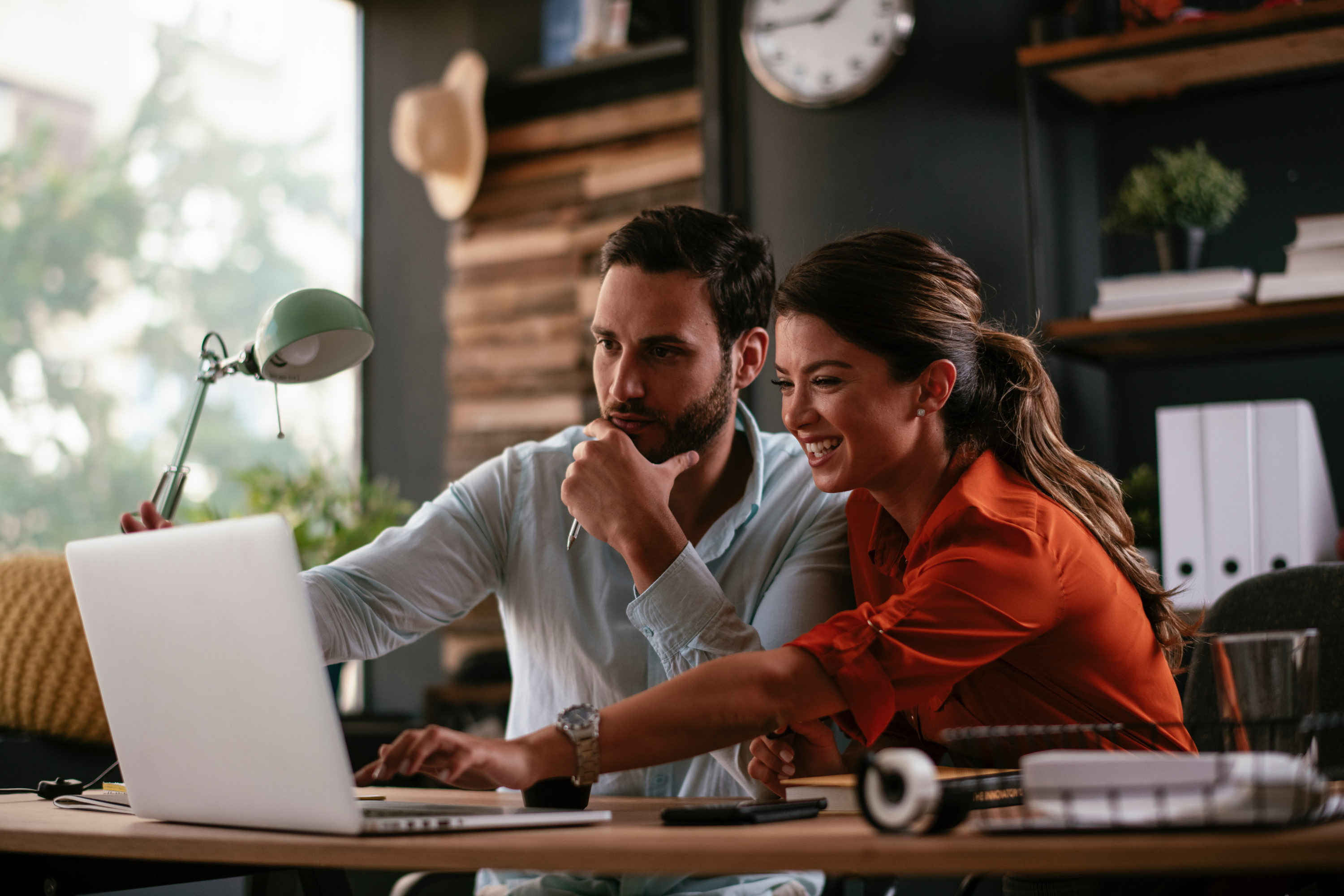 Man and woman with laptop on desk