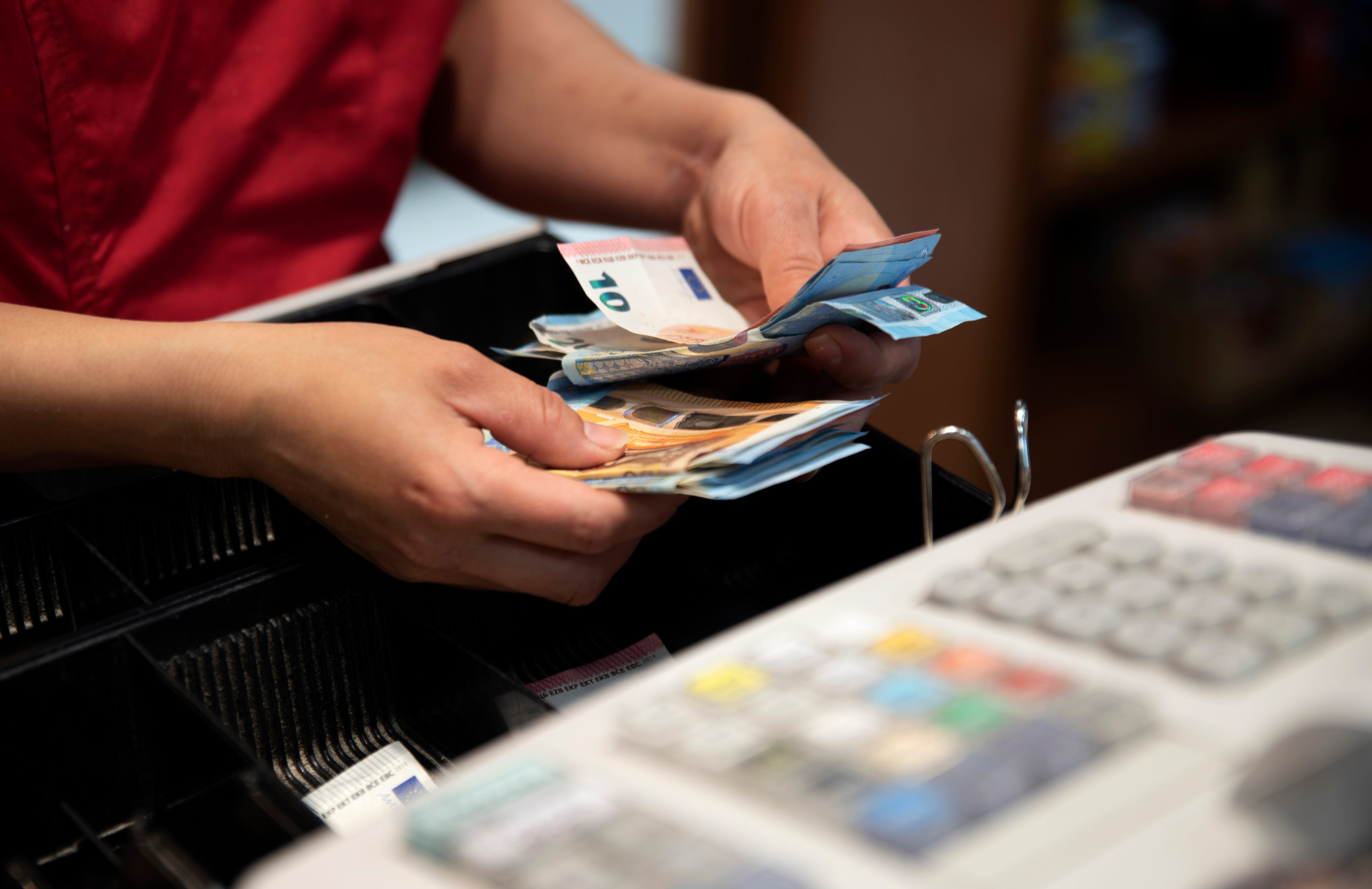 Cashier counting euros Cashier counting euros