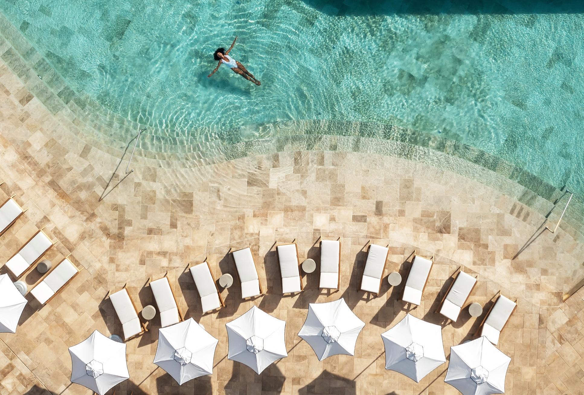 Six Senses Ibiza A woman floats in a hotel pool