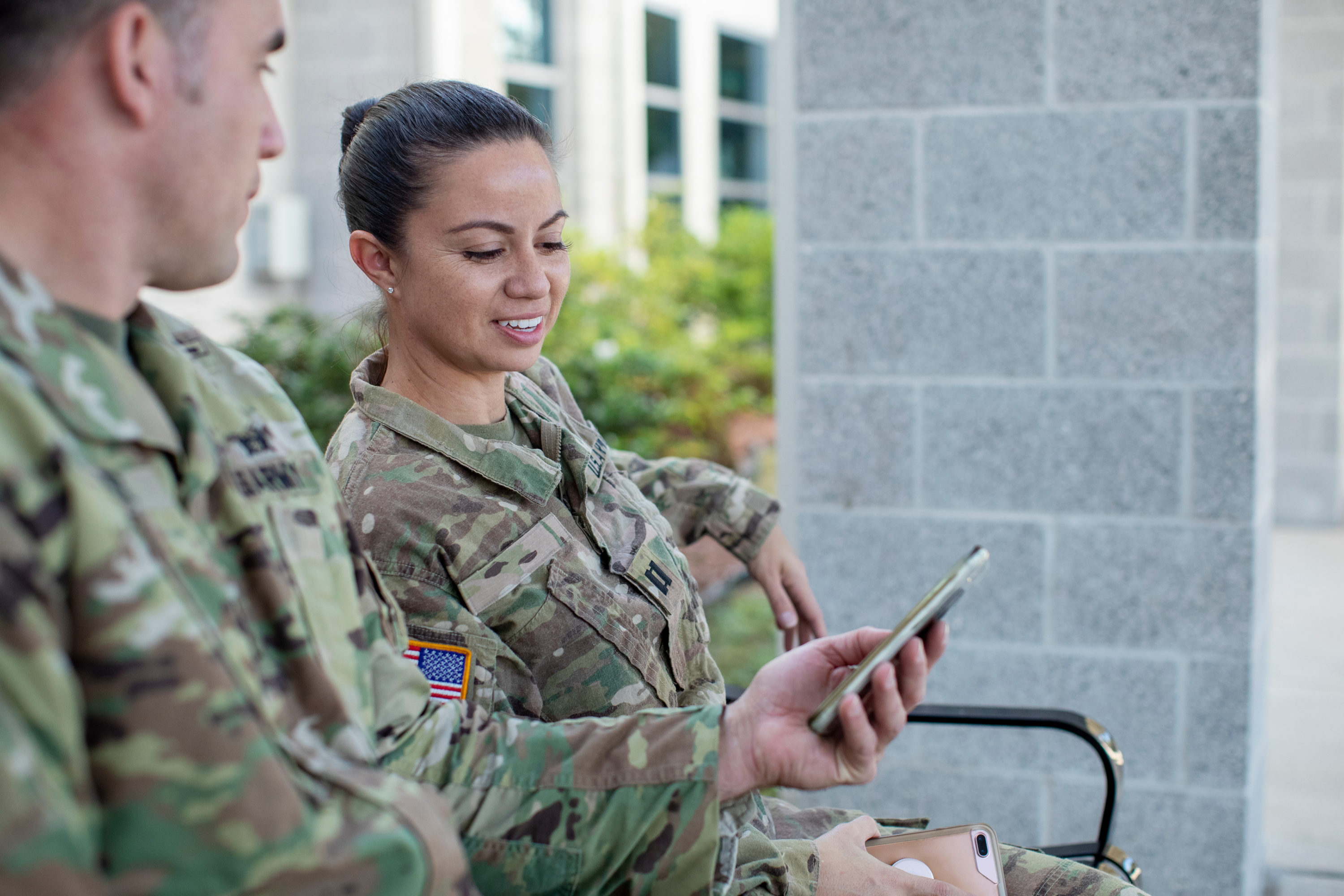 Soldiers looking at a cell phone Soldiers looking at a cell phone