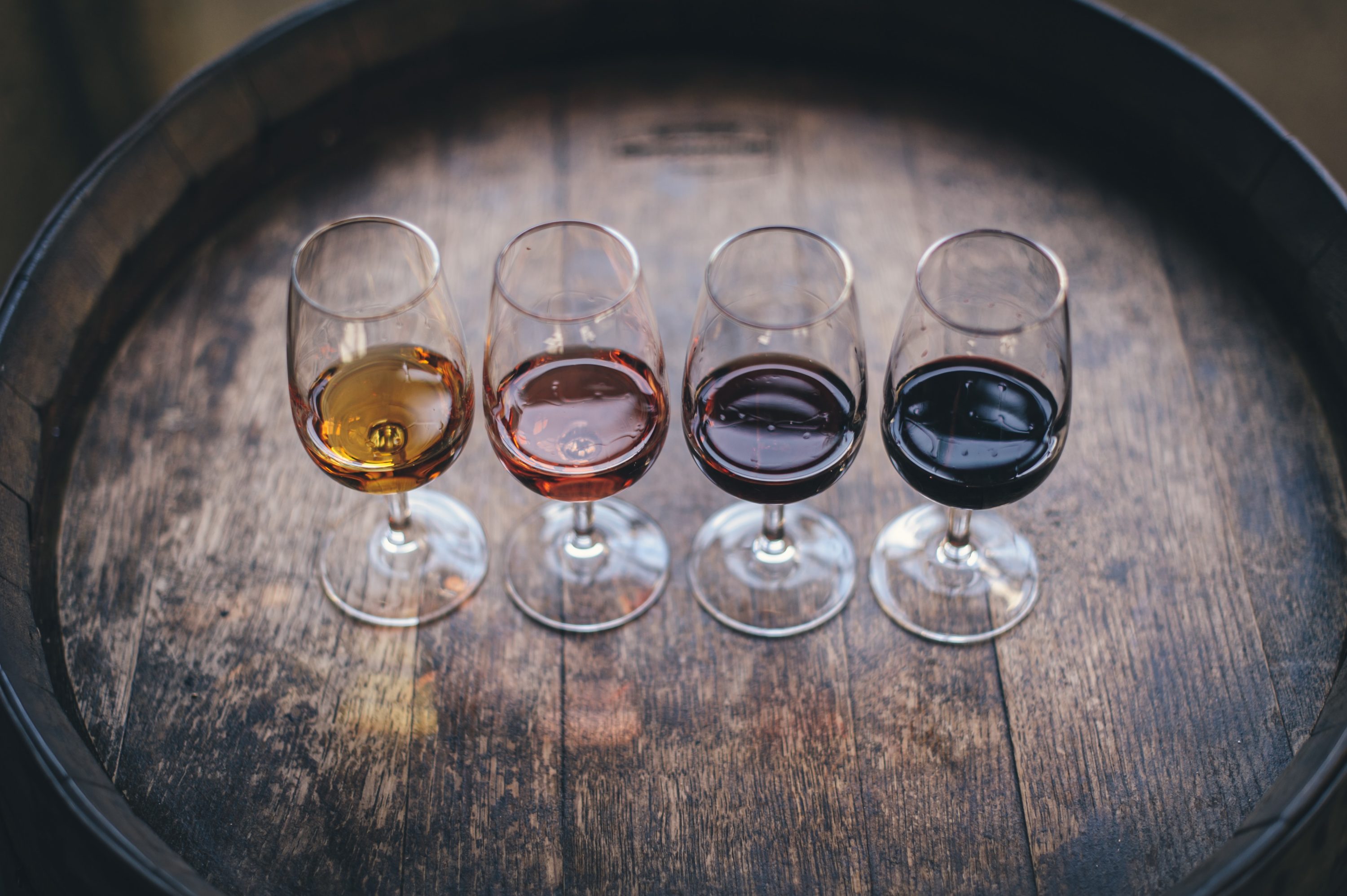 4 wine glasses on a barrel