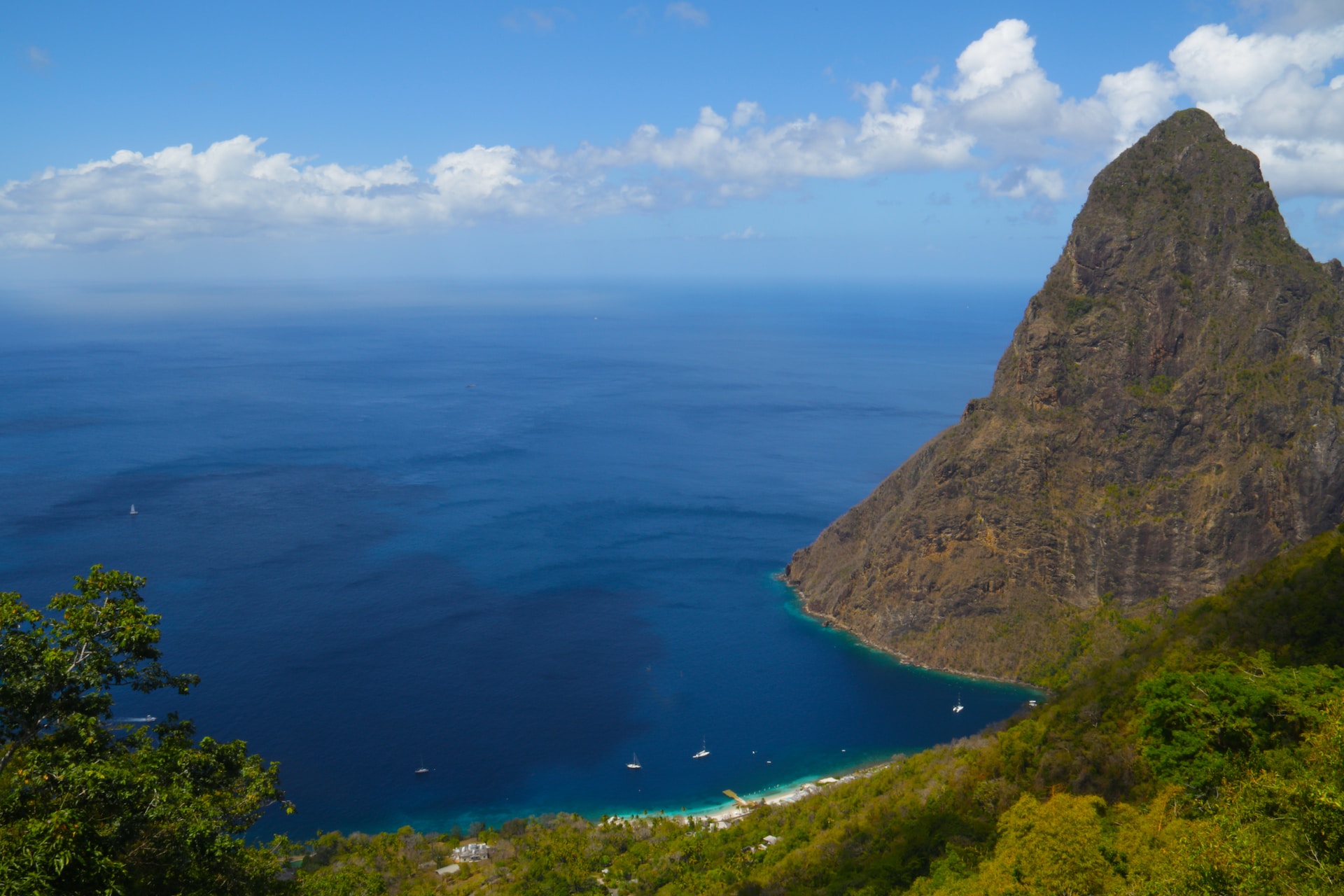 A mountain, beach, and rainforest in St. Lucia overlookign the ocean