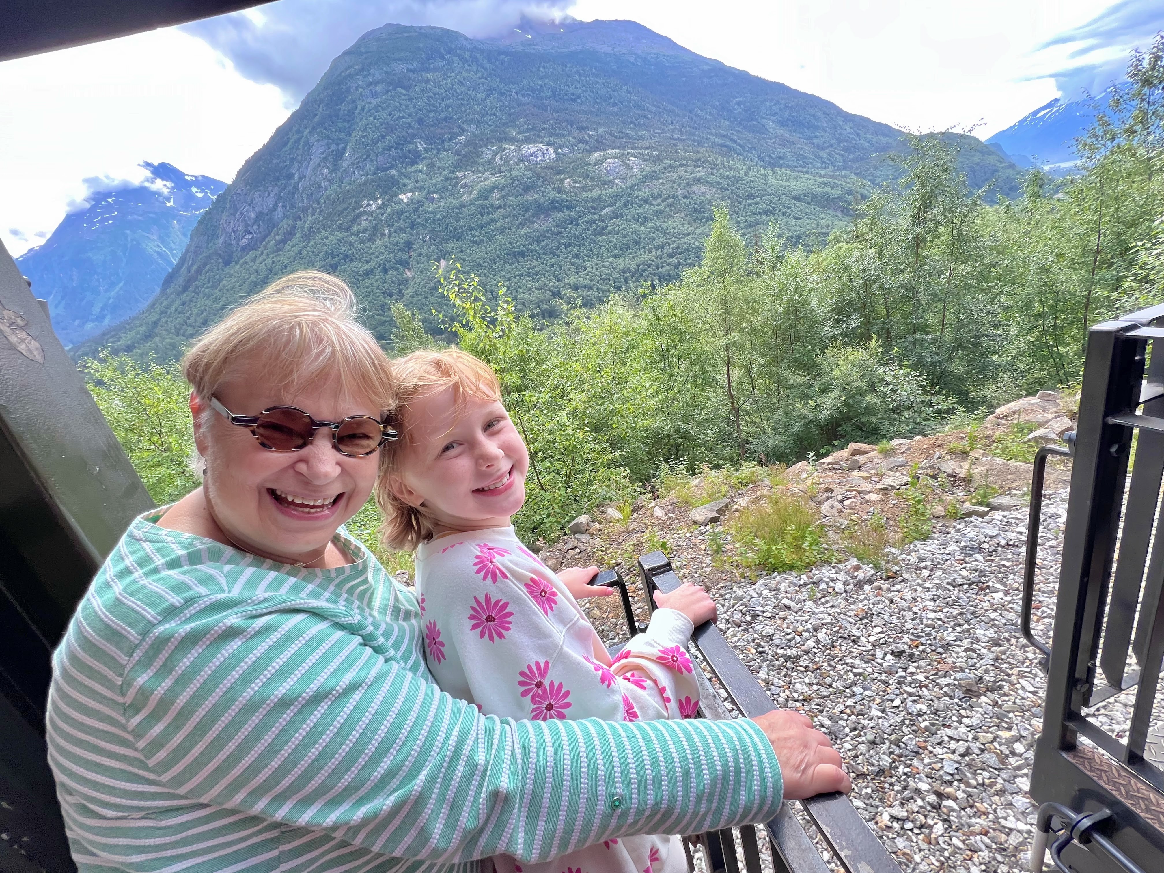 Riding on the White Pass Railroad outside platform in Skagway Alaska Riding on the White Pass Railroad outside platform in Skagway Alaska