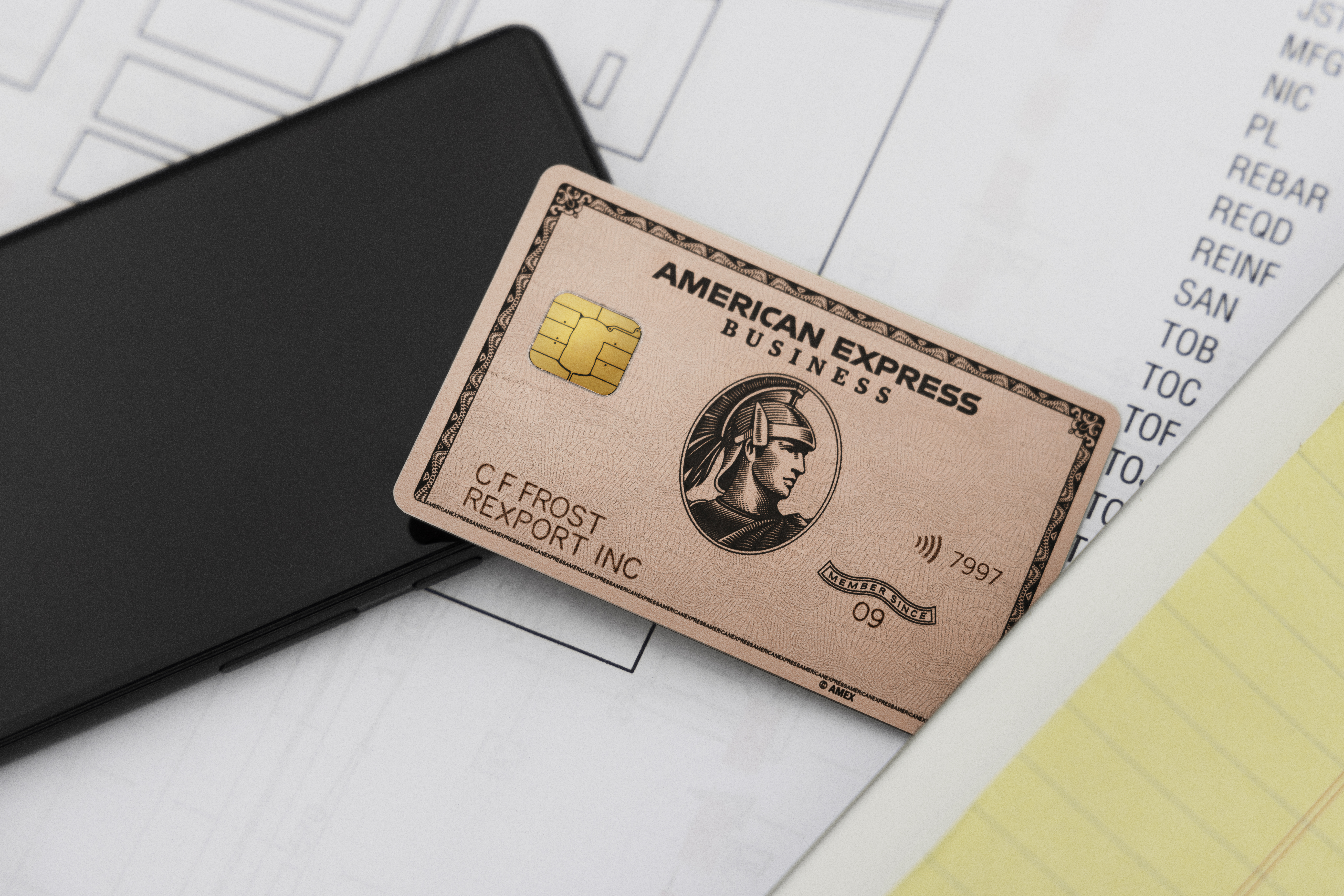 Amex Business Rose Gold Card on top of paperwork Amex Business Rose Gold Card on top of paperwork