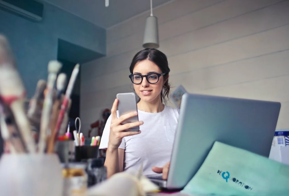 Business Owner with Phone and Laptop Business Owner with Phone and Laptop