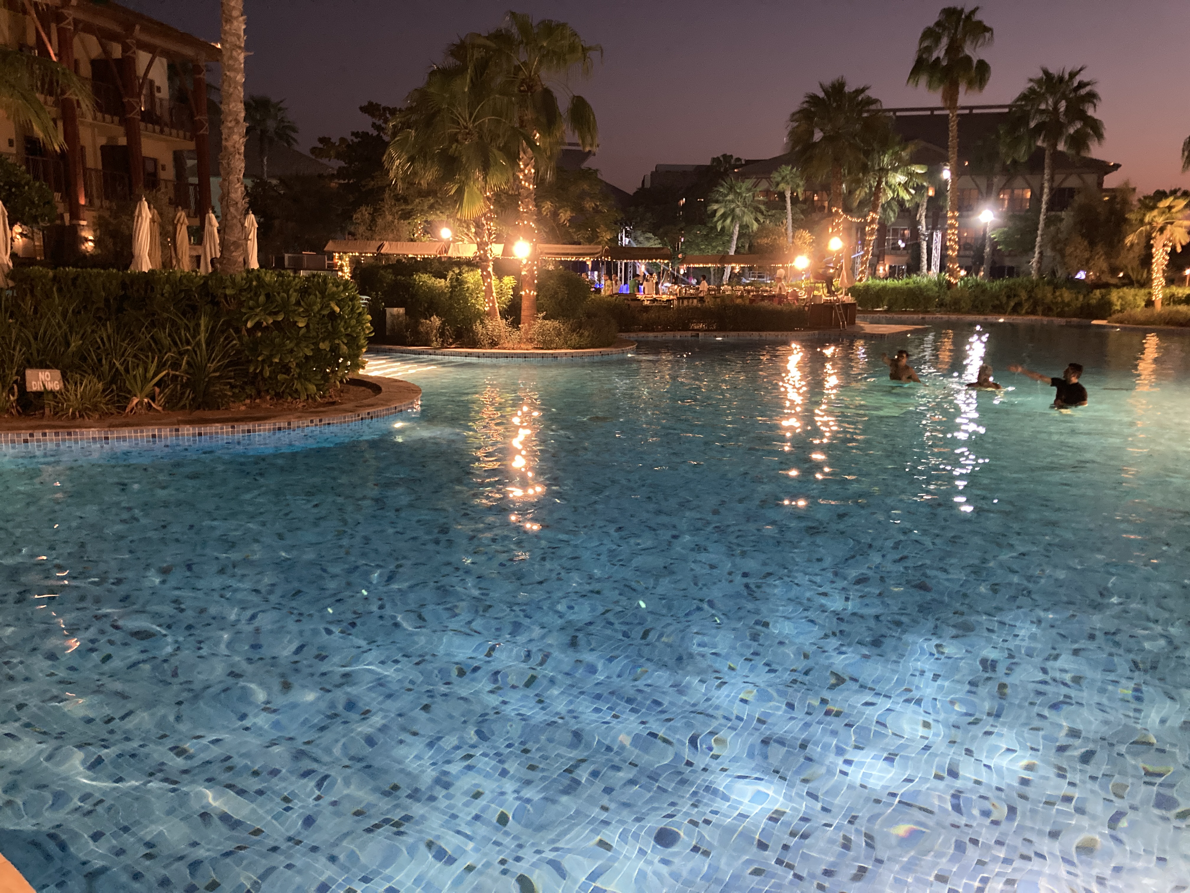 Lapita Dubai Parks and Resorts Autograph Collection main pool at night Lapita Dubai Parks and Resorts Autograph Collection main pool at night