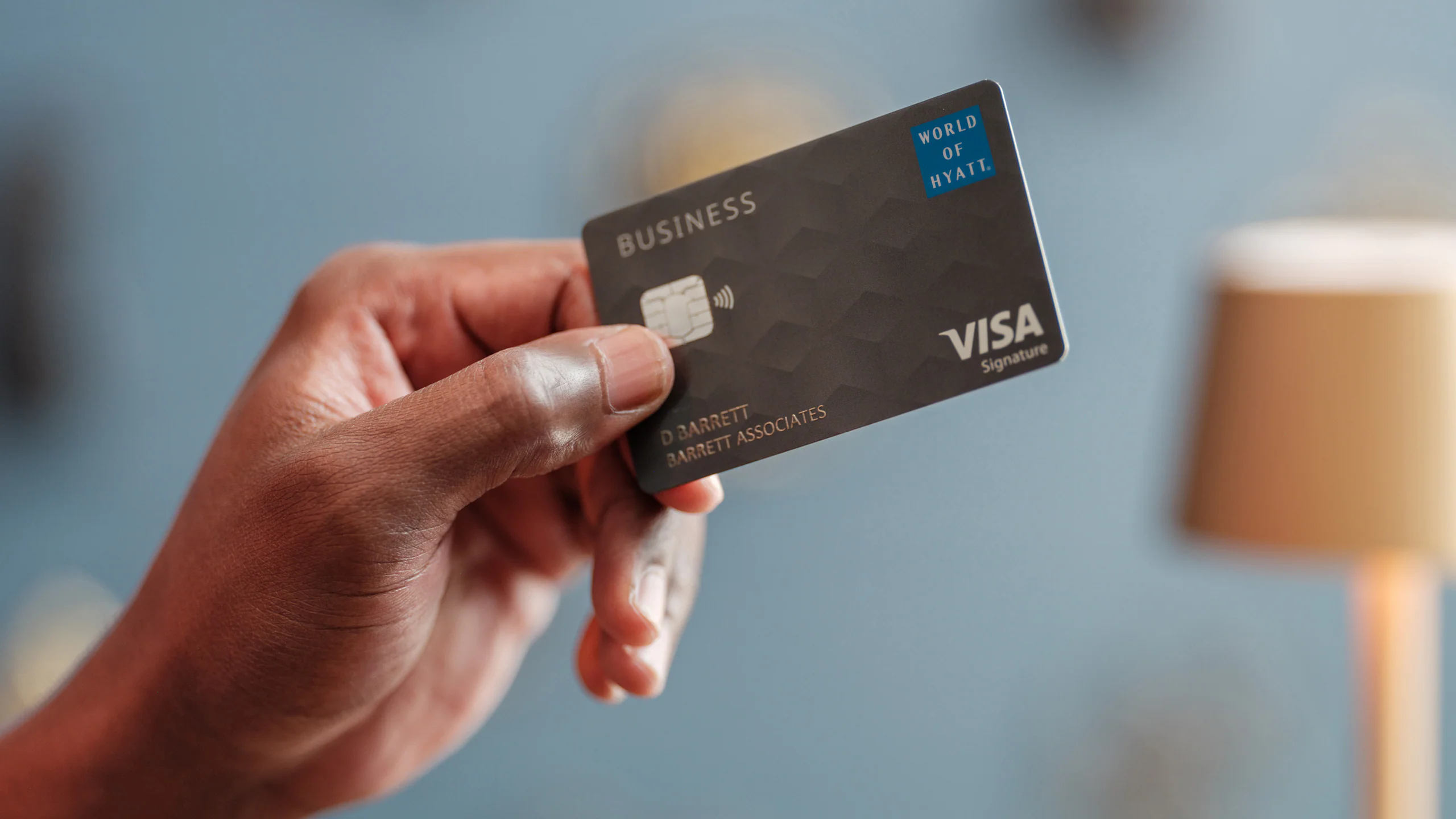 Man Presenting World of Hyatt Business Card