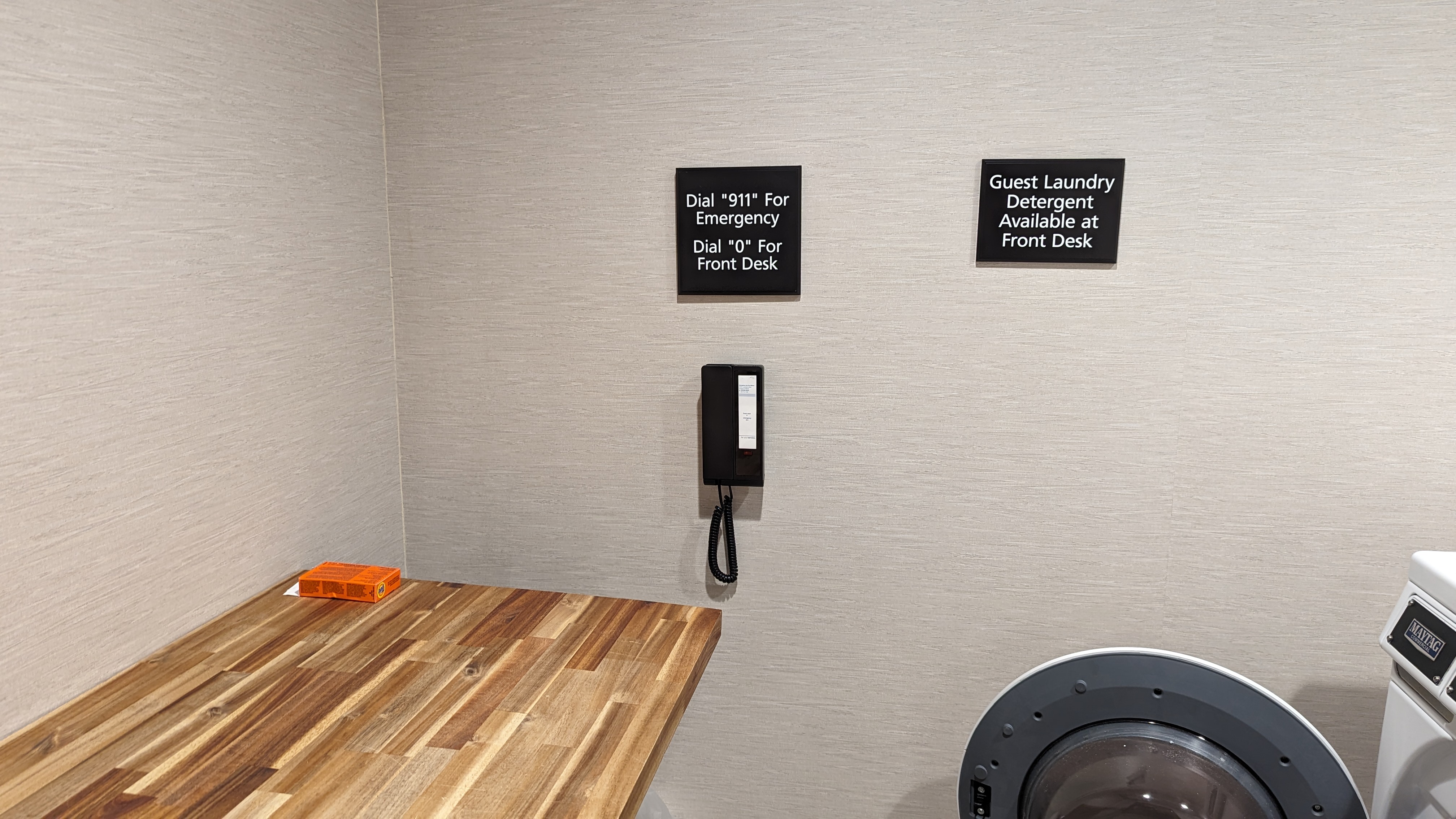 Hampton Inn and Suites Aurora South Denver amenities laundry room table and phone