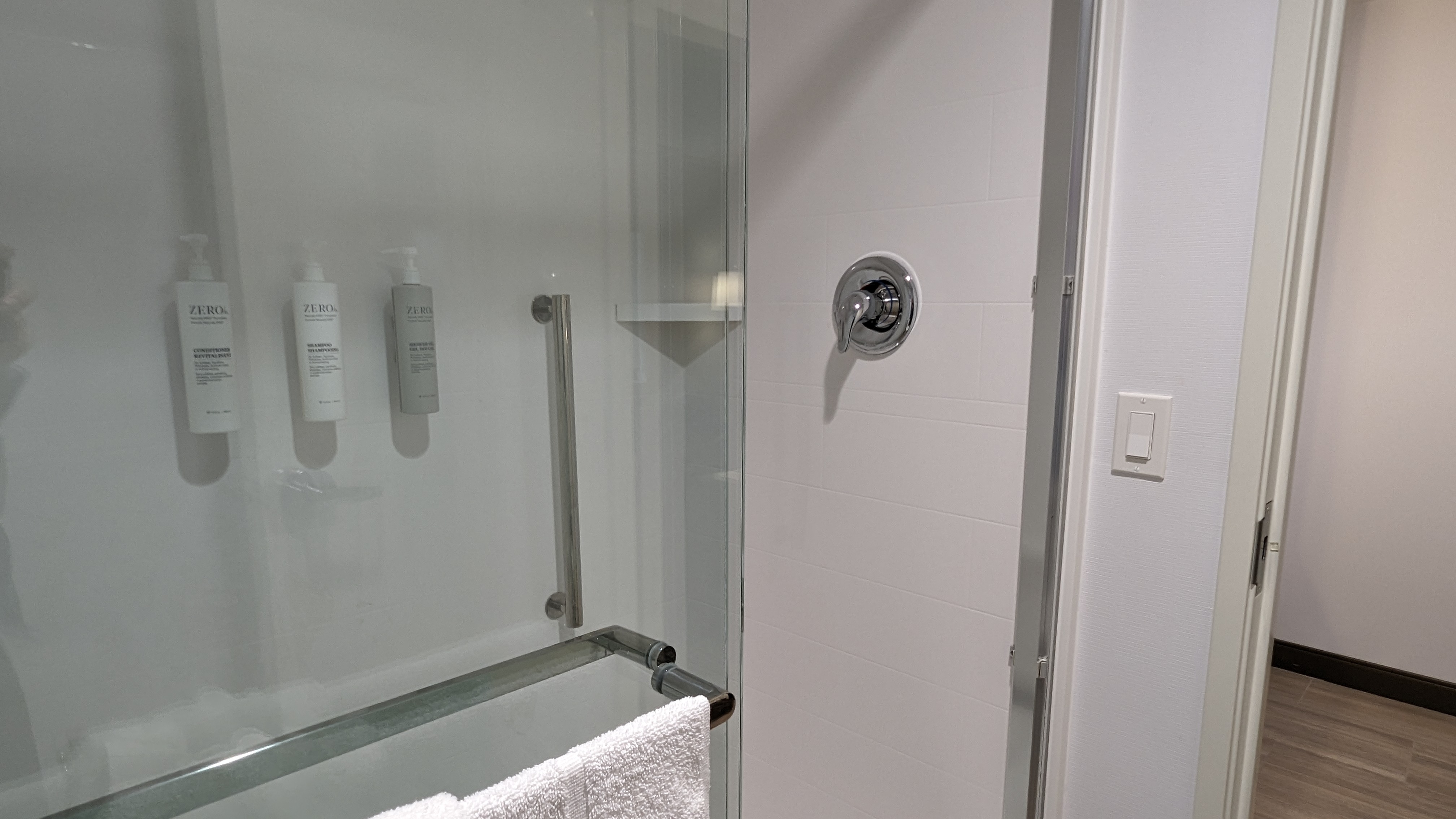 Hampton Inn and Suites Aurora South Denver room bathroom shower door
