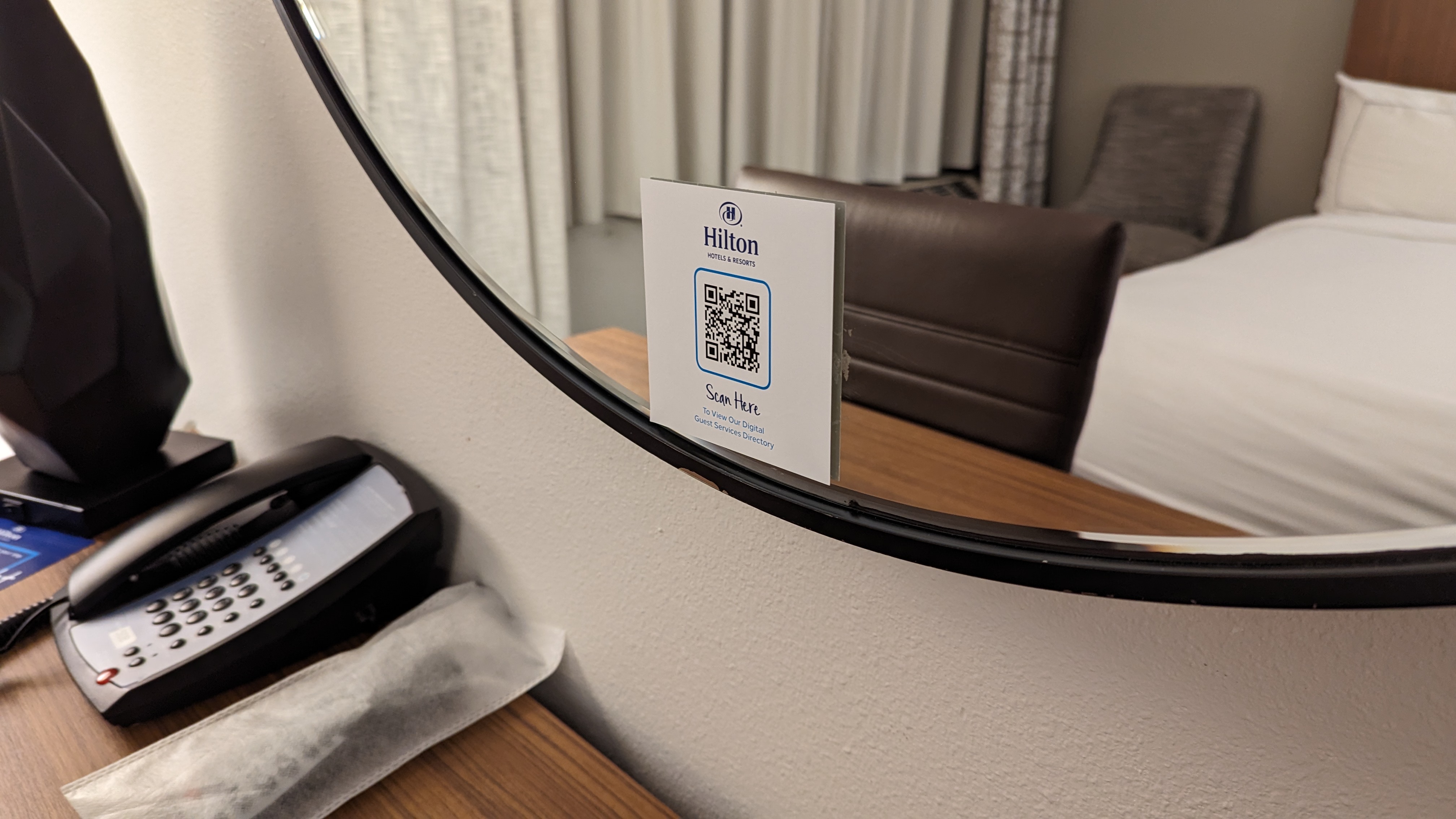 Hilton Pensacola Beach guestroom information mirror and phone