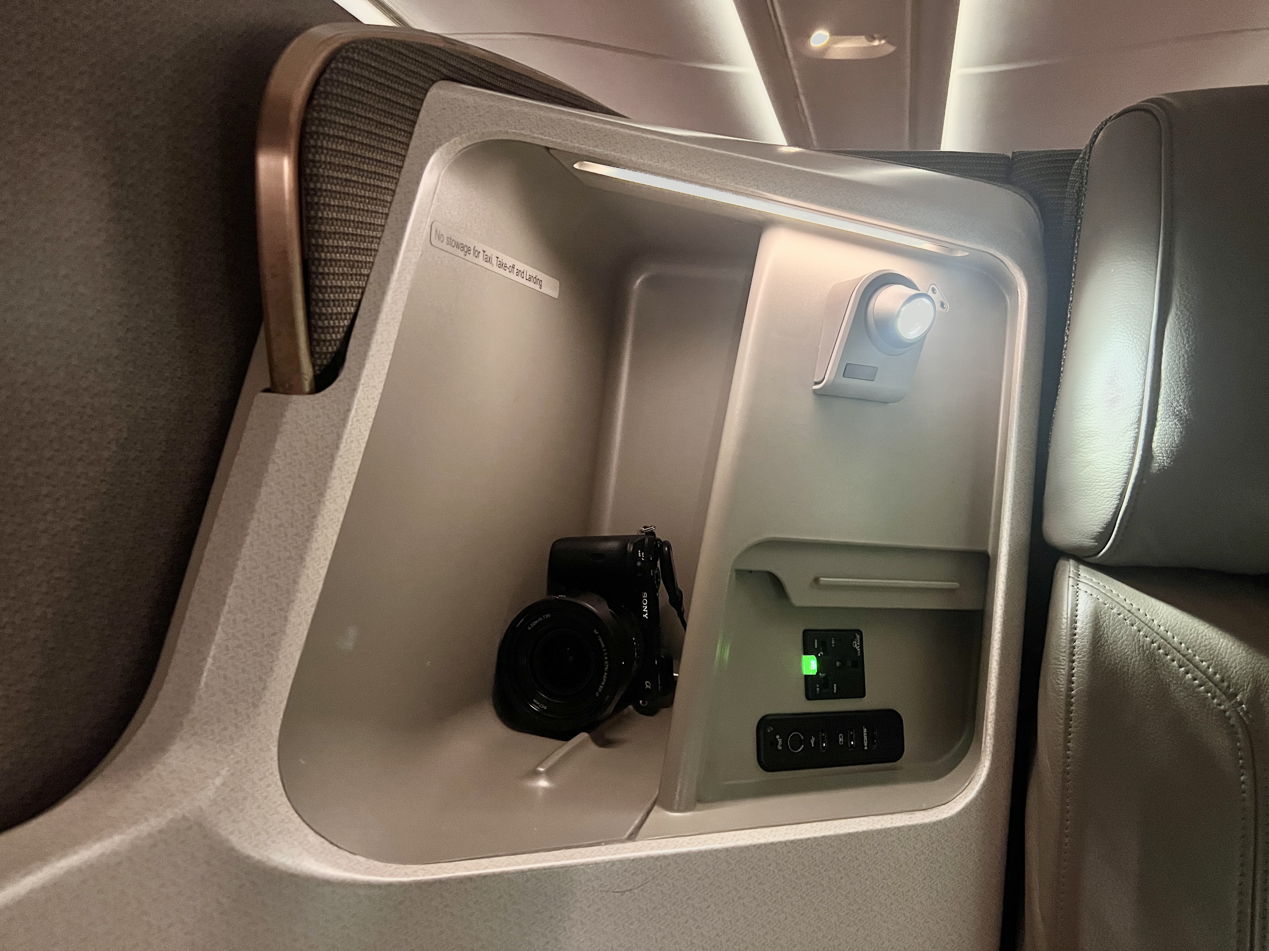 Singapore business 777 storage compartment next to power Singapore business 777 storage compartment next to power