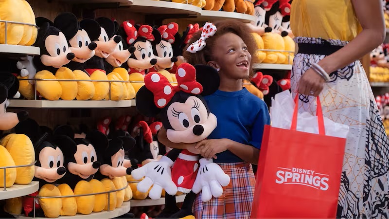 Child at Plush Wall World of Disney