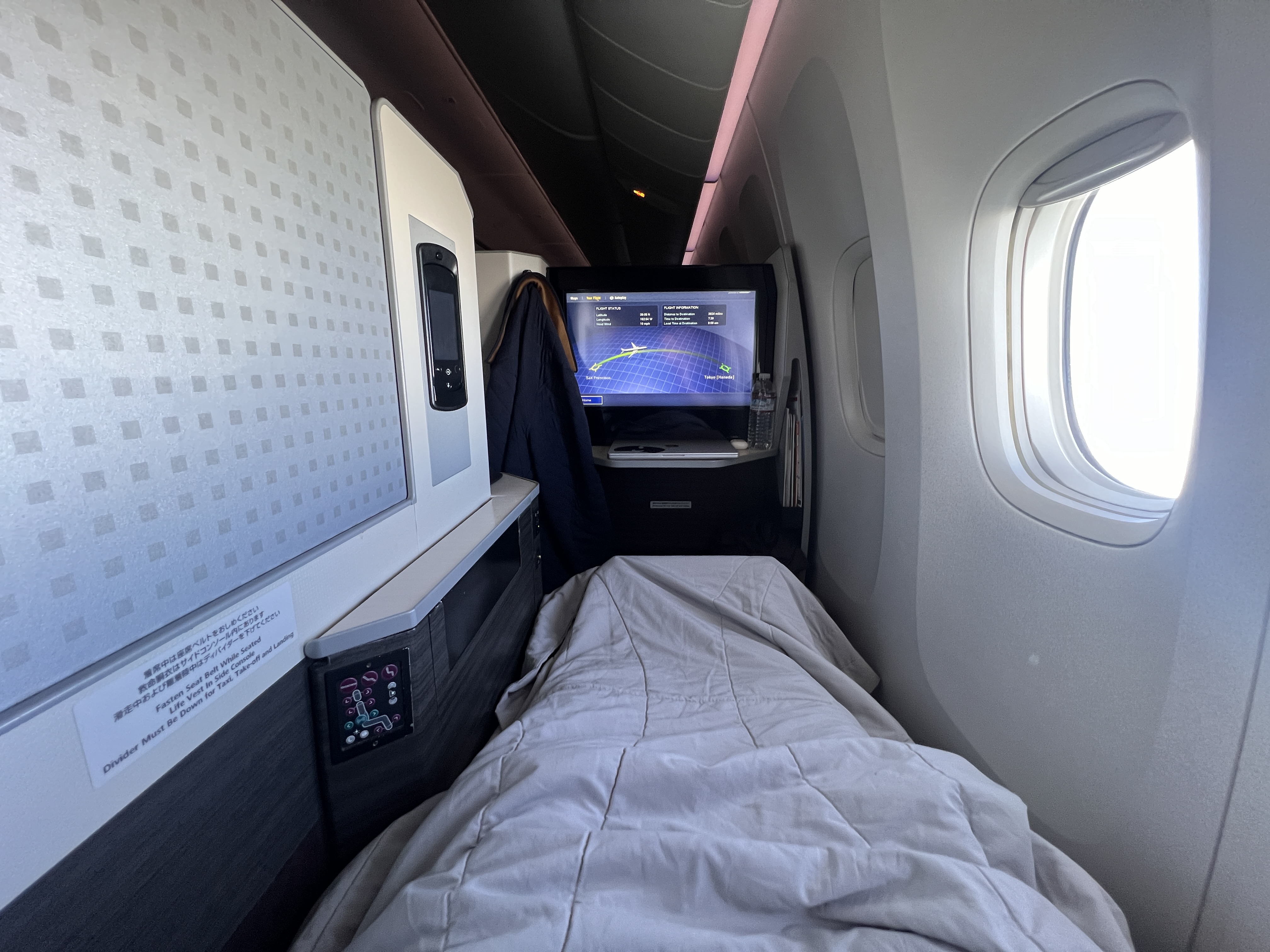 Japan Airlines 777 300er business class laying in bed Japan Airlines 777 300er business class laying in bed