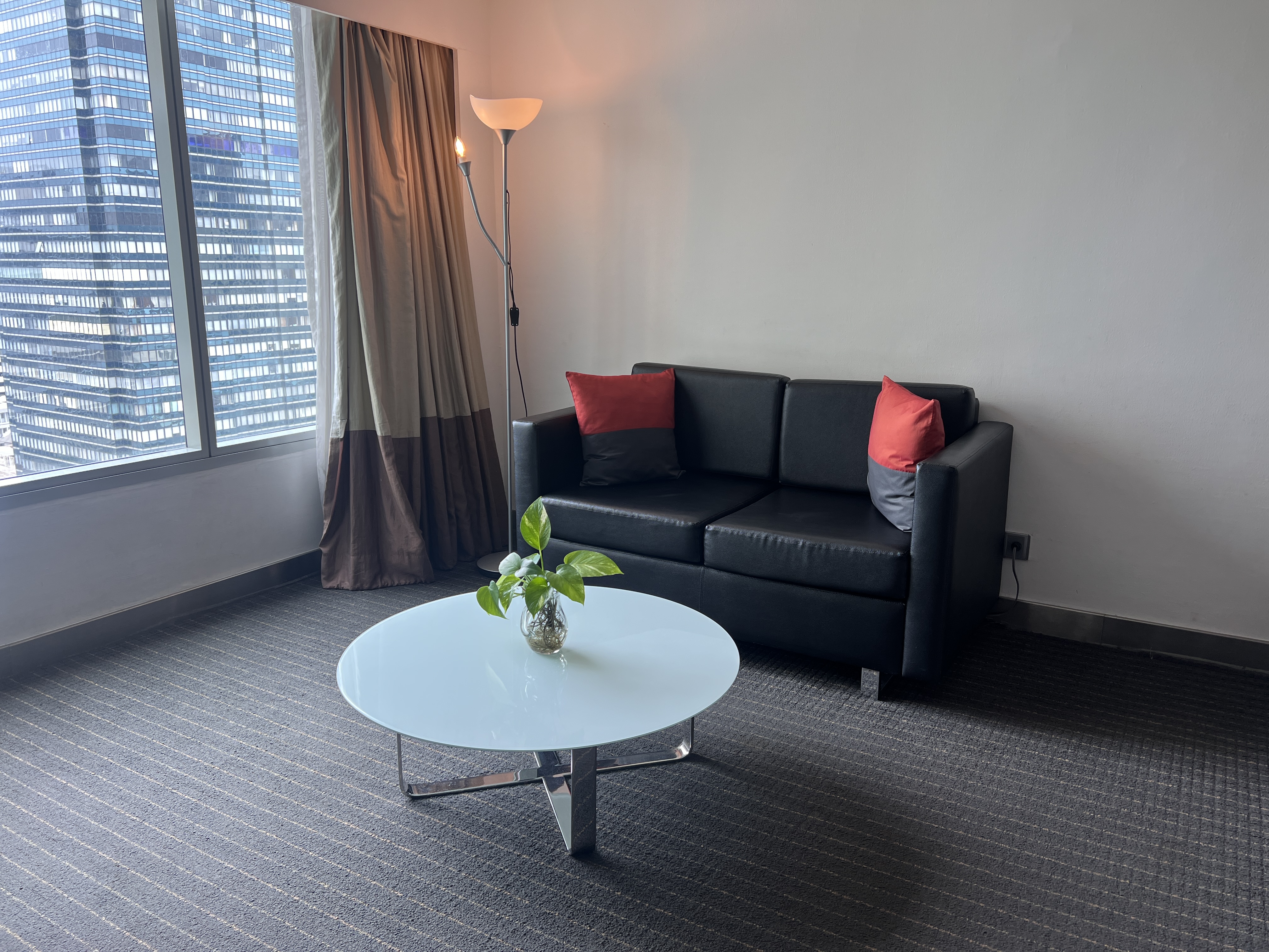 Hilton Garden Inn Bangkok Silom living room and sofa