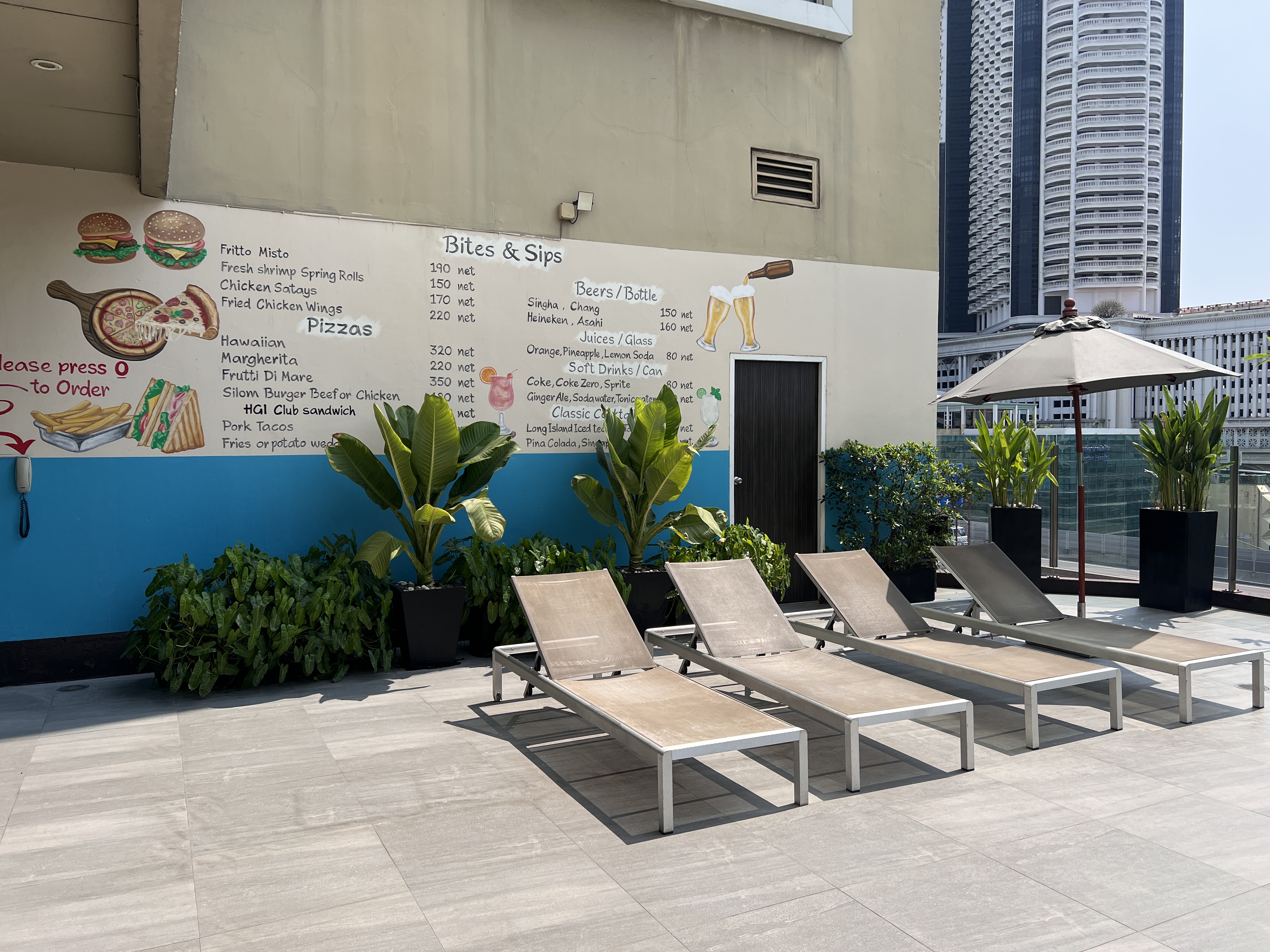 Hilton Garden Inn Bangkok Silom rooftop outdoor pool seating