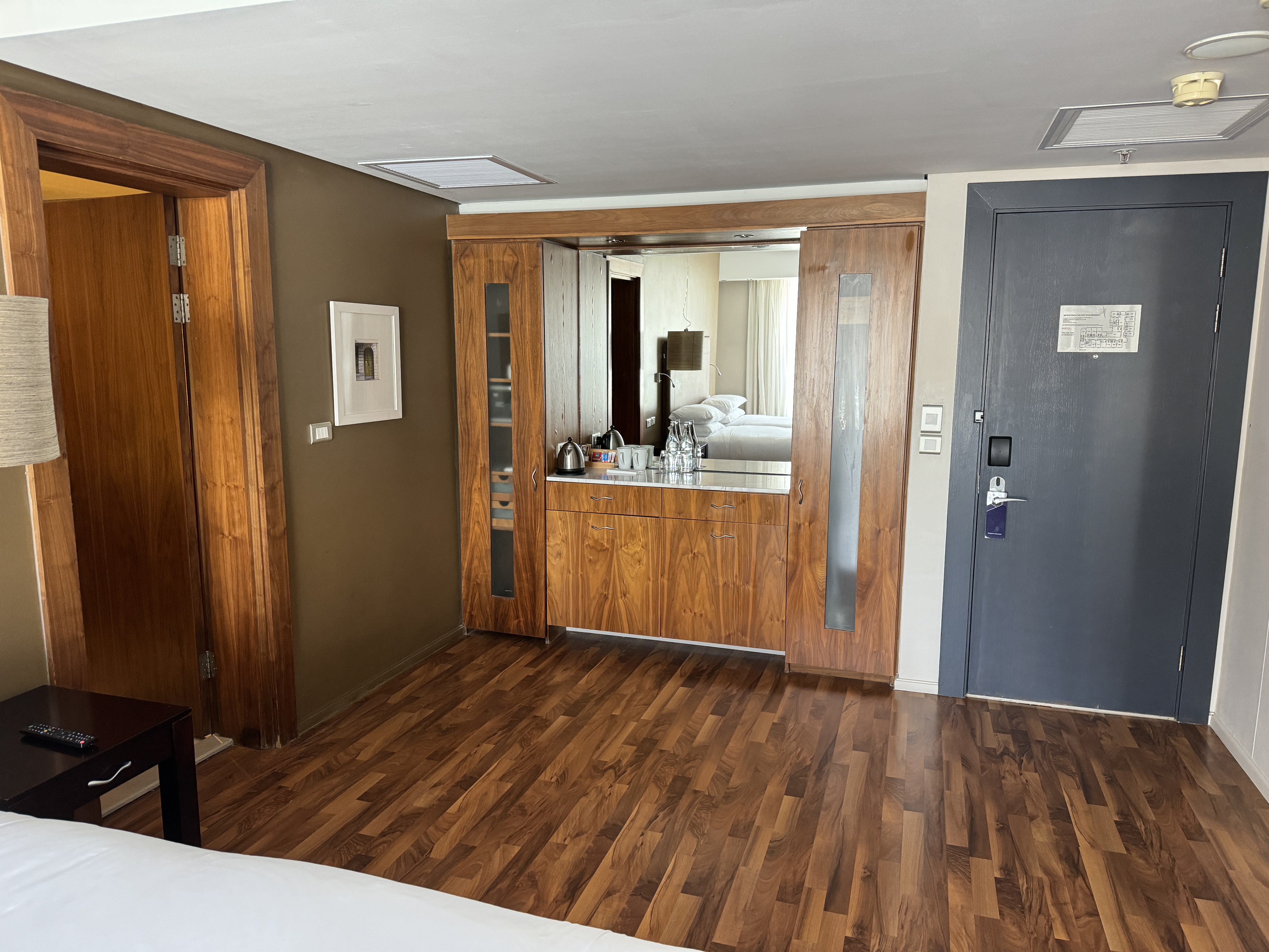 A view of the space between the beds and the closet and counter area shows the closets on either side, drawers and cabinets. A view of the space between the beds and the closet and counter area shows the closets on either side, drawers and cabinets.