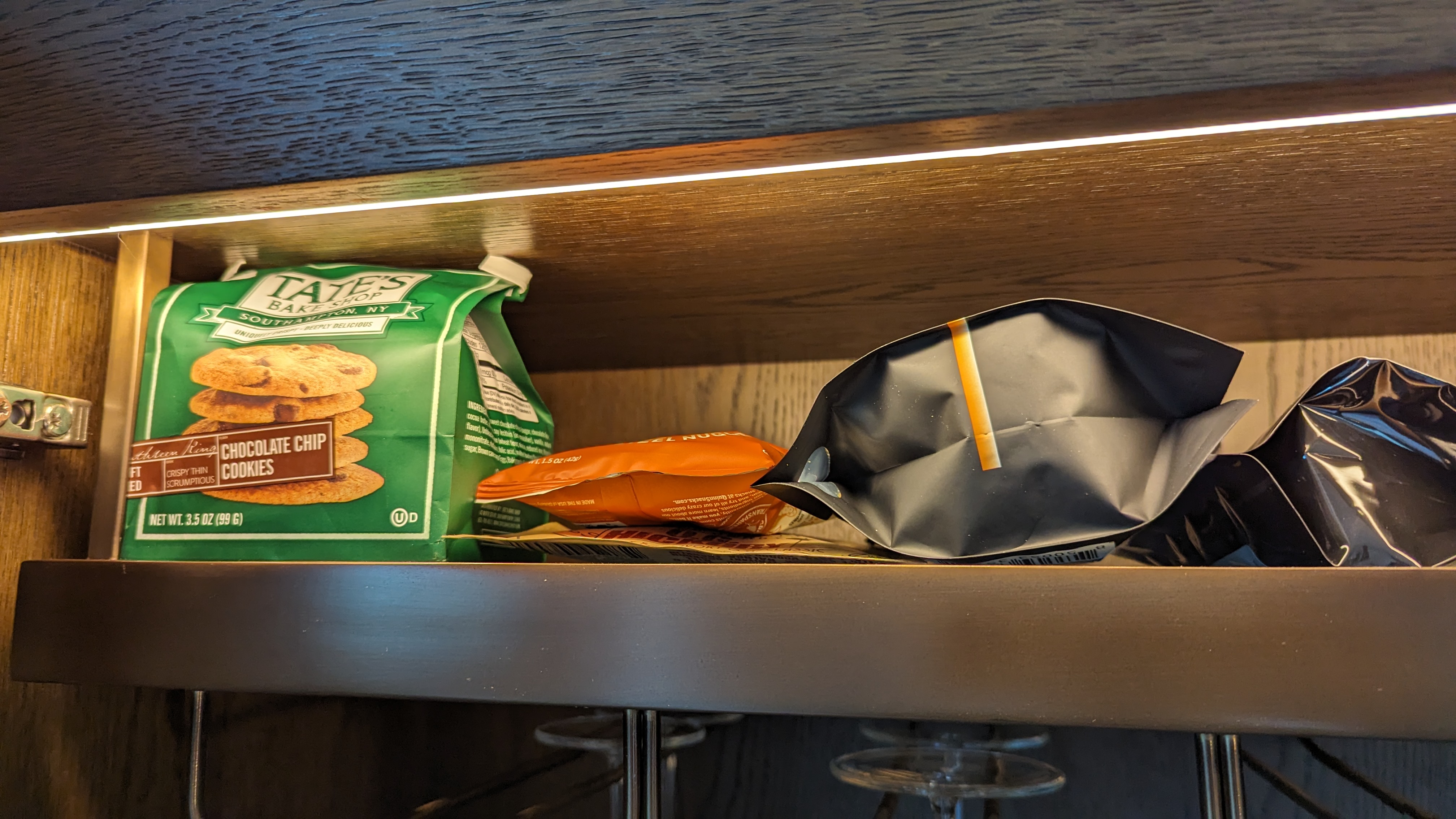 Thompson Houston guestroom bedroom minibar snacks Thompson Houston guestroom bedroom minibar snacks