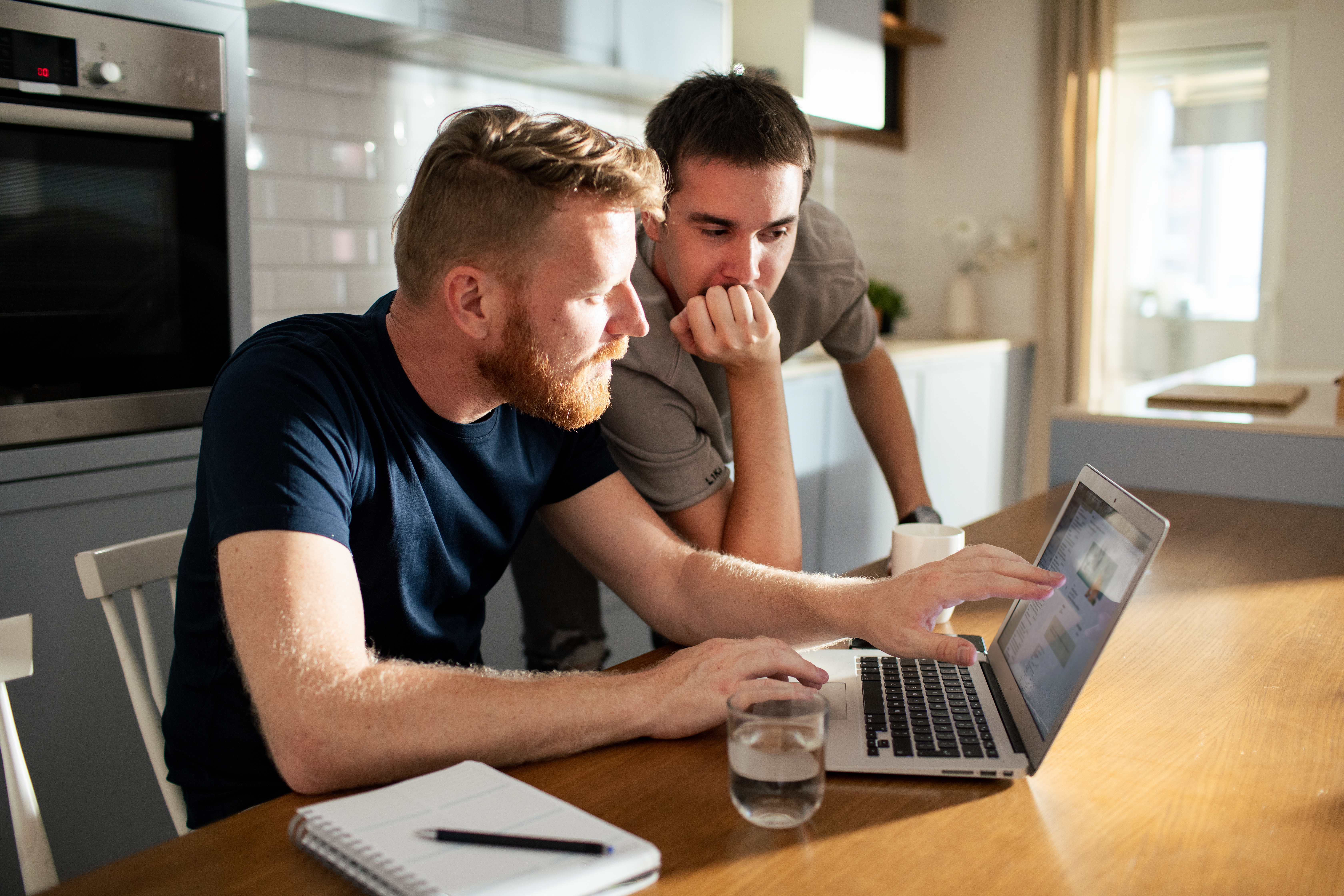 2 men reviewing laptop 2 men reviewing laptop
