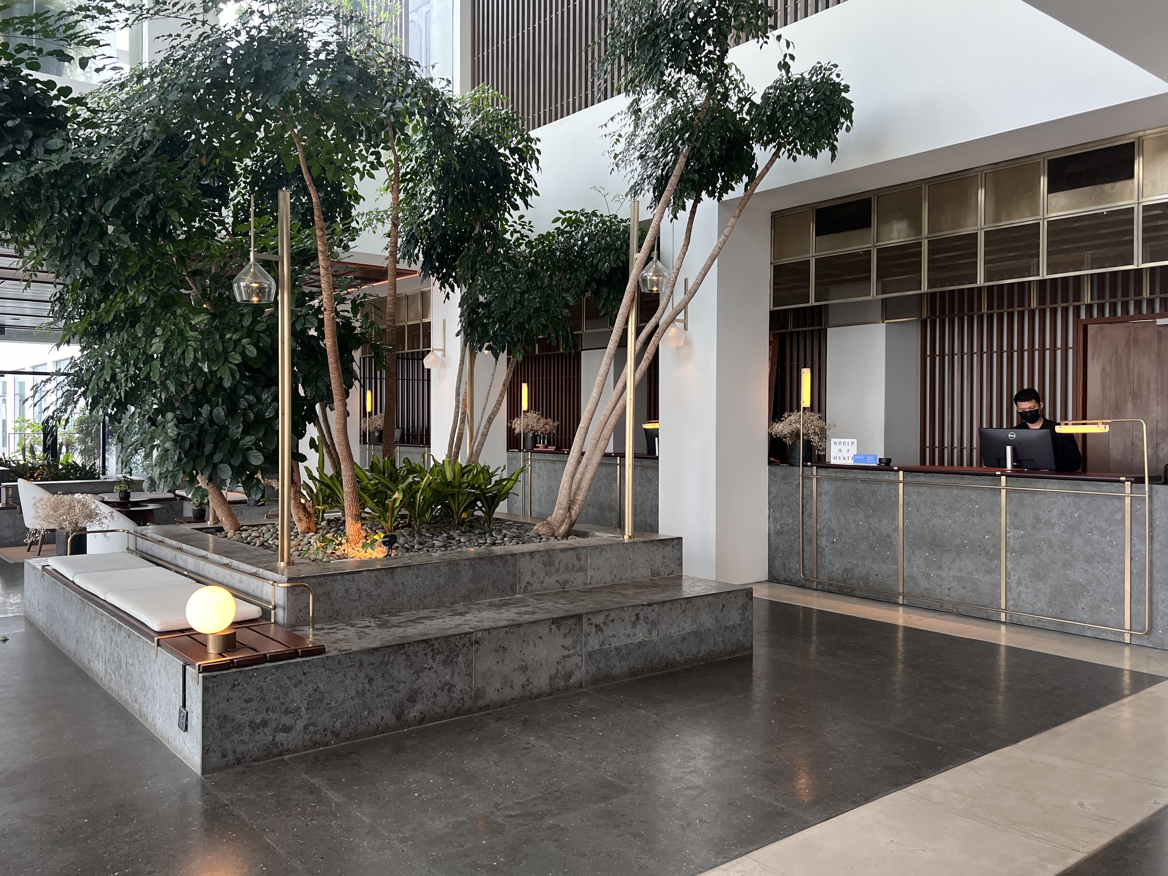 Alila Bangsar Kuala Lumpur lobby check in desk and trees Alila Bangsar Kuala Lumpur lobby check in desk and trees