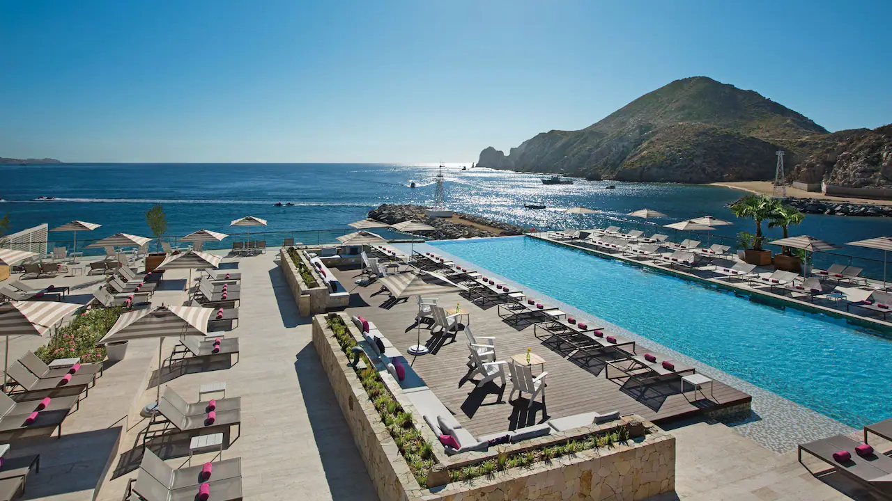 Breathless Cabo An aerial image of the pool at Breathless Cabo San Lucas Resort & Spa overlooking the ocean.