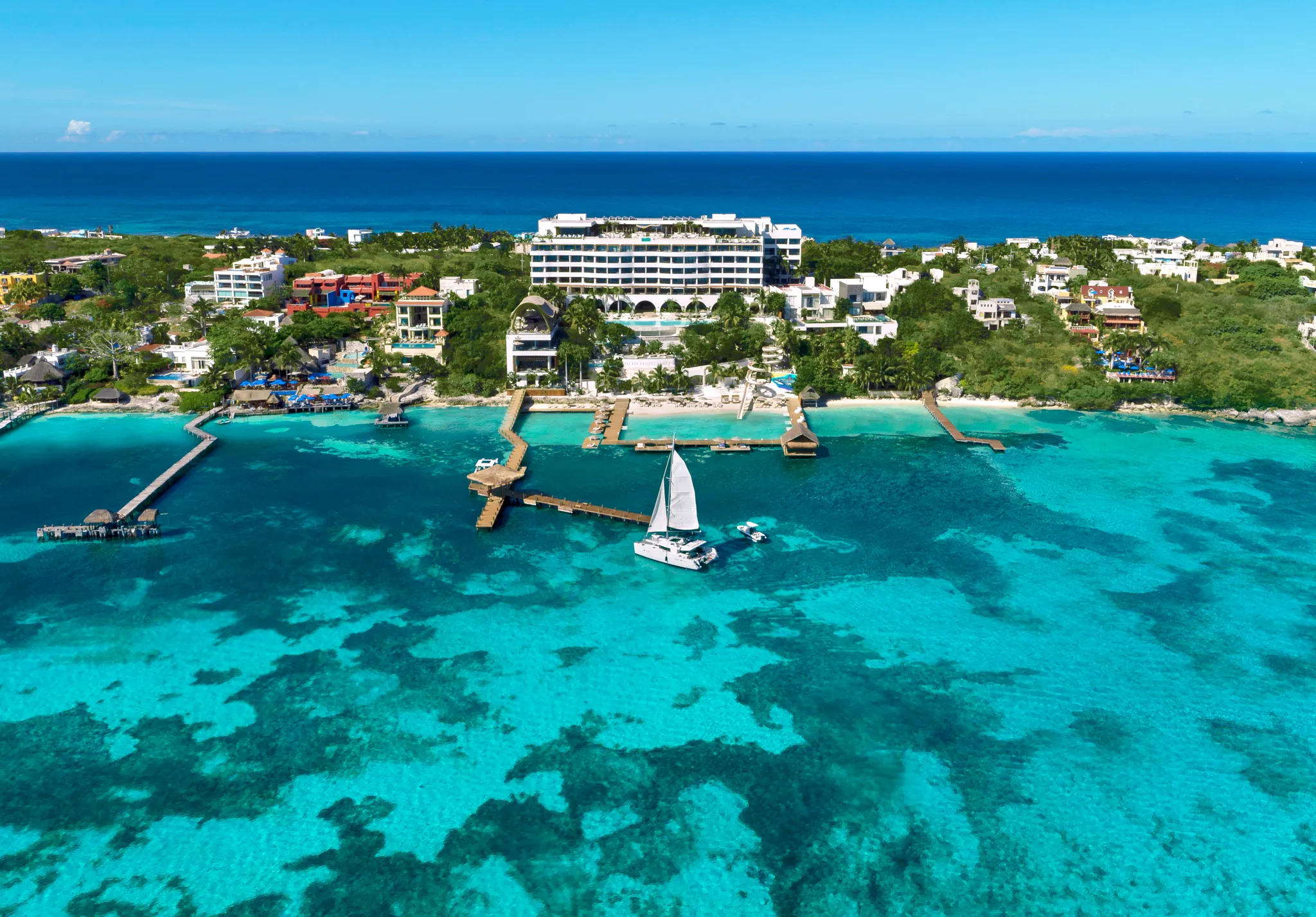 Impressions Isla Mujeres by Secrets An aerial photo of Impressions Isla Mujeres by Secrets from the water.