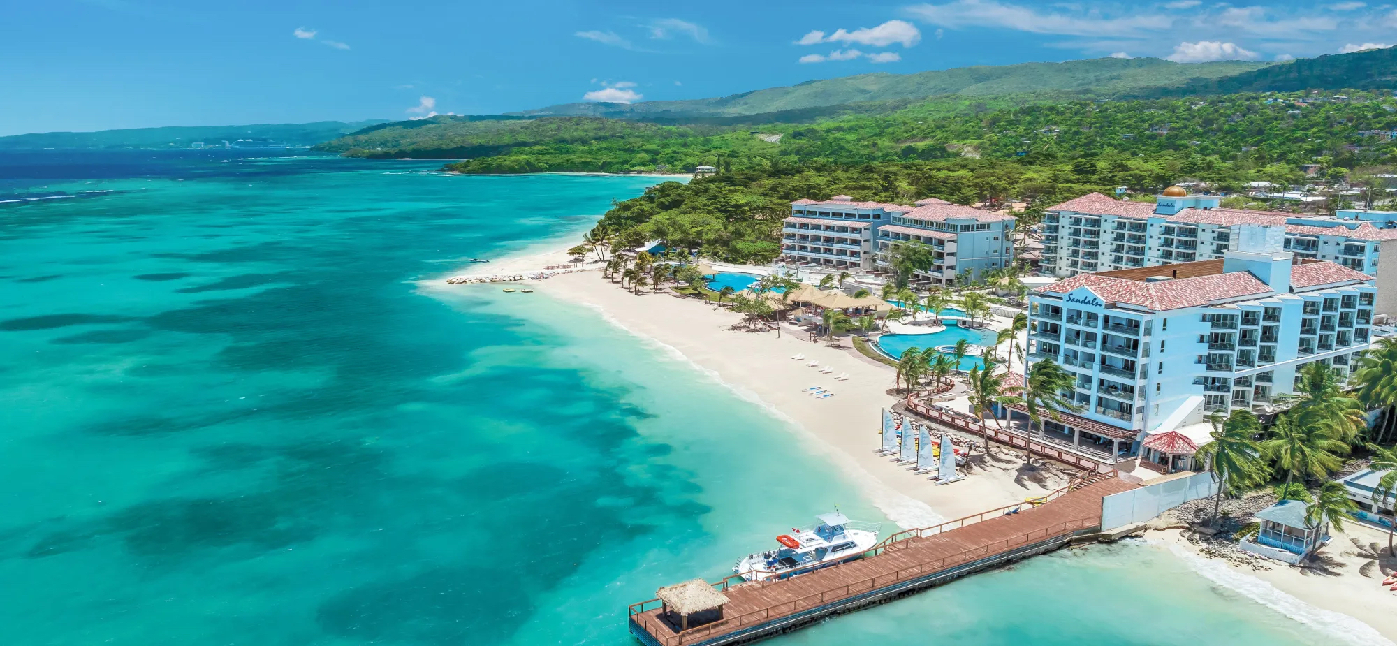 Sandals Dunns River An aerial photo of the hotel, dock, and beach at Sandals Dunns River.