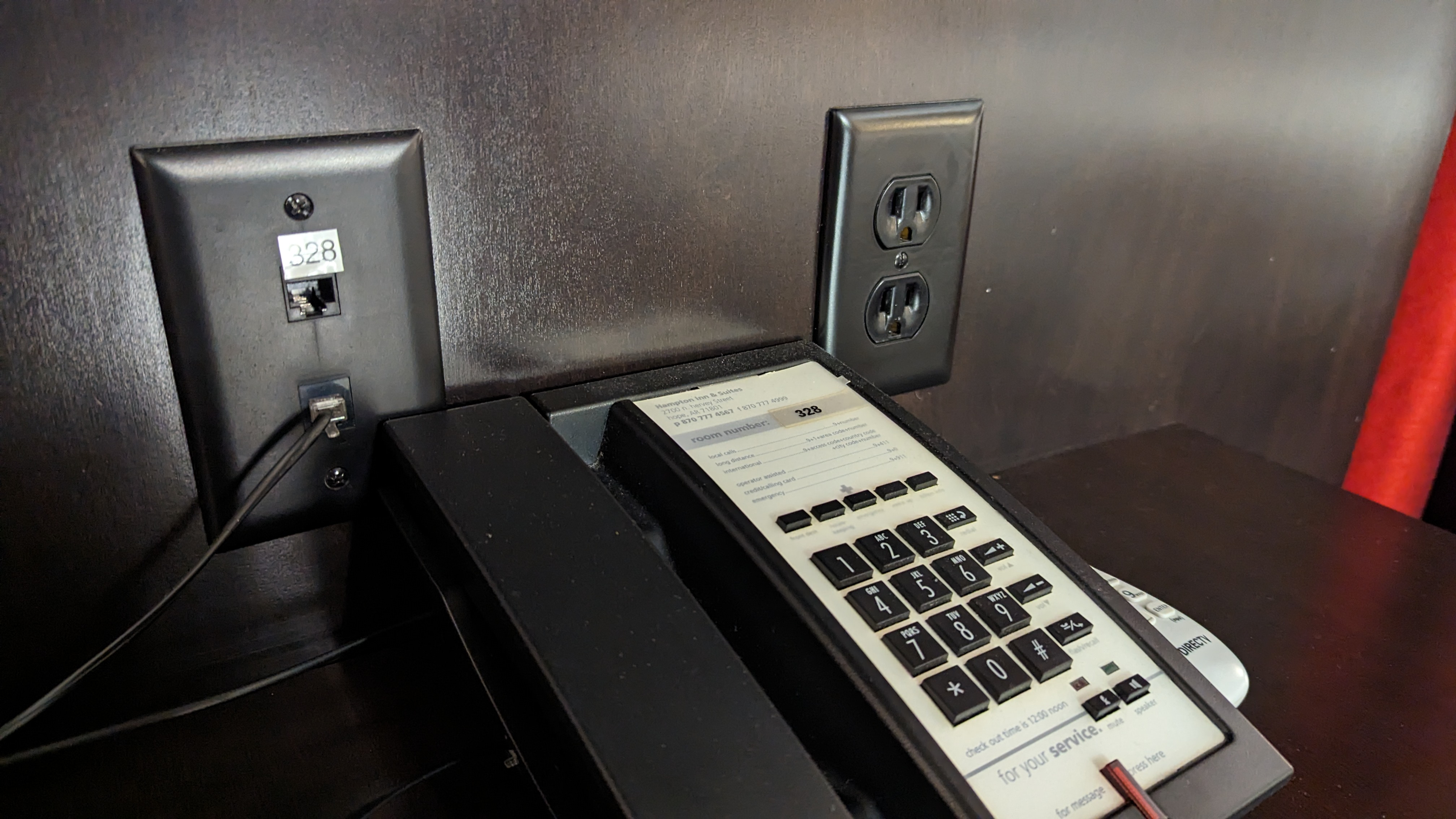 Hampton Inn Suites Hope guestroom nightstand phone and outlet