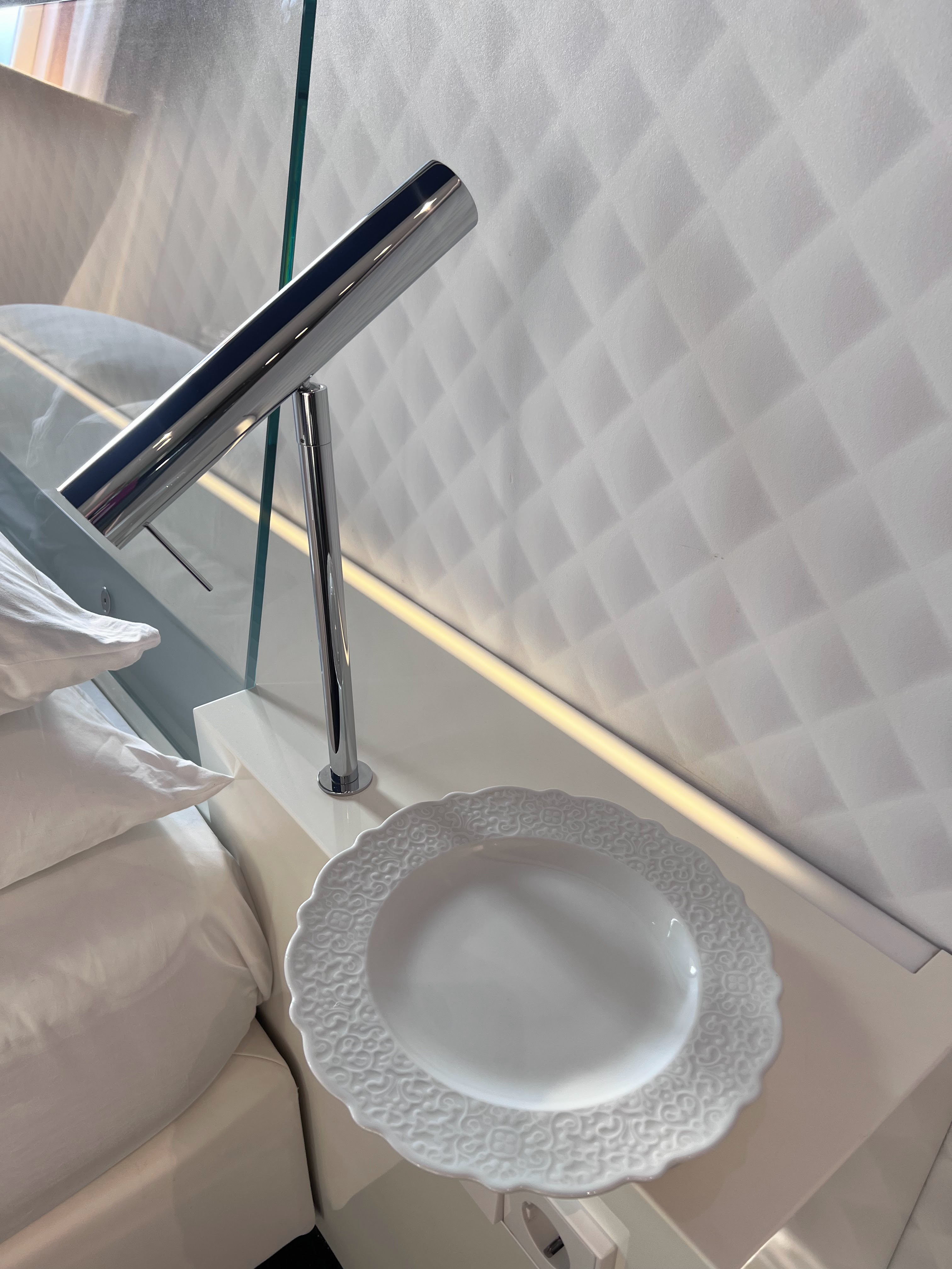 Plate by side of bed at Andaz Amsterdam Plate by side of bed at Andaz Amsterdam