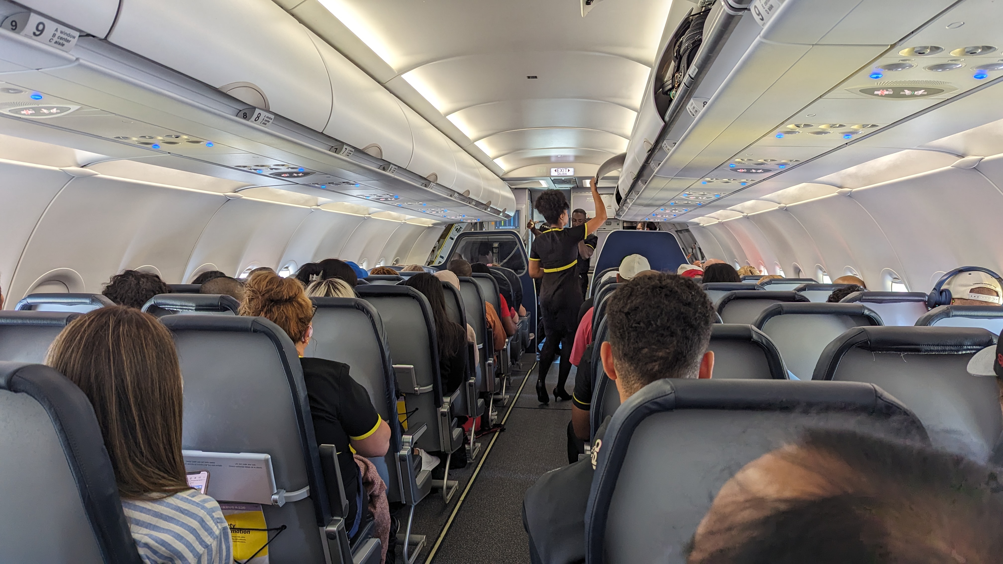 IAH to LAS Spirit cabin looking up the aisle with passengers and flight attendants on a Spirit flight