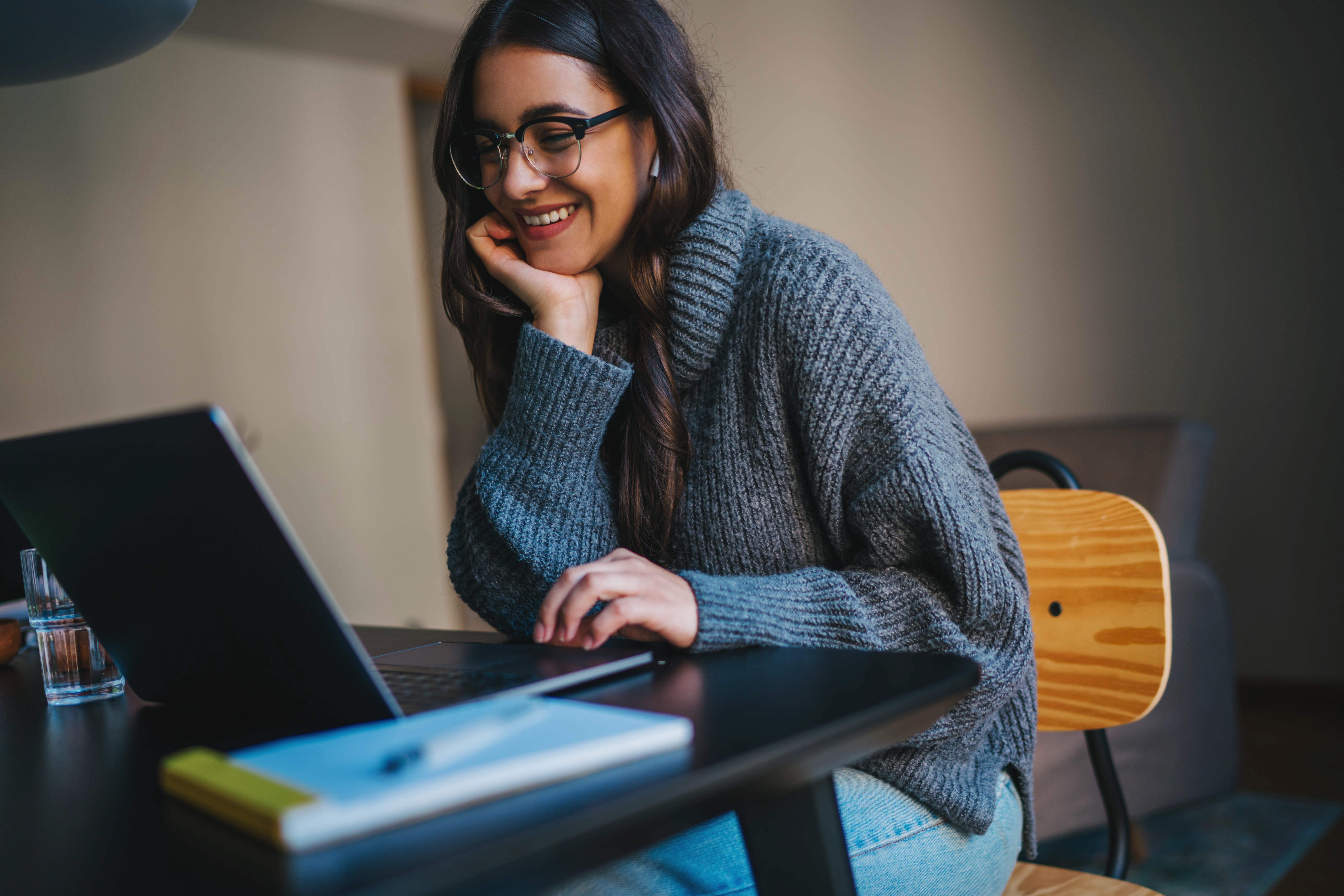 Woman smiling at computer Woman smiling at computer