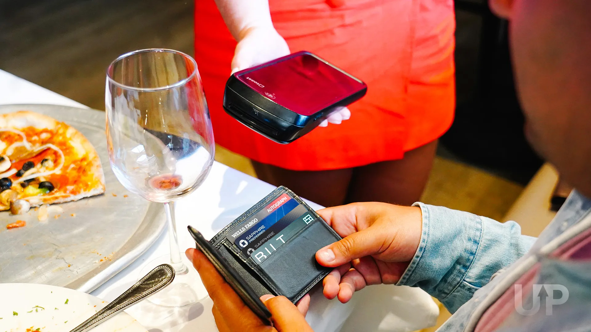 Person looking at phone and printout Wells Fargo Autograph Journey Chase Sapphire Preferred Sapphire Reserve Bilt Card in Wallet Upgraded Points LLC 2