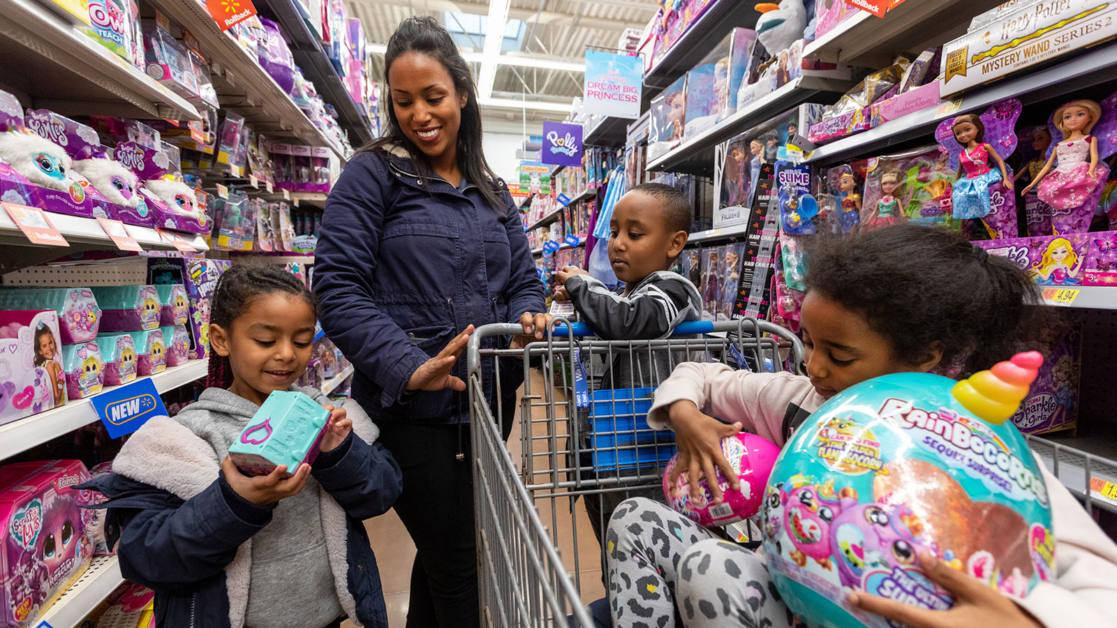 a family checks out new holiday toys in a walmart store aisle a family checks out new holiday toys in a walmart store aisle