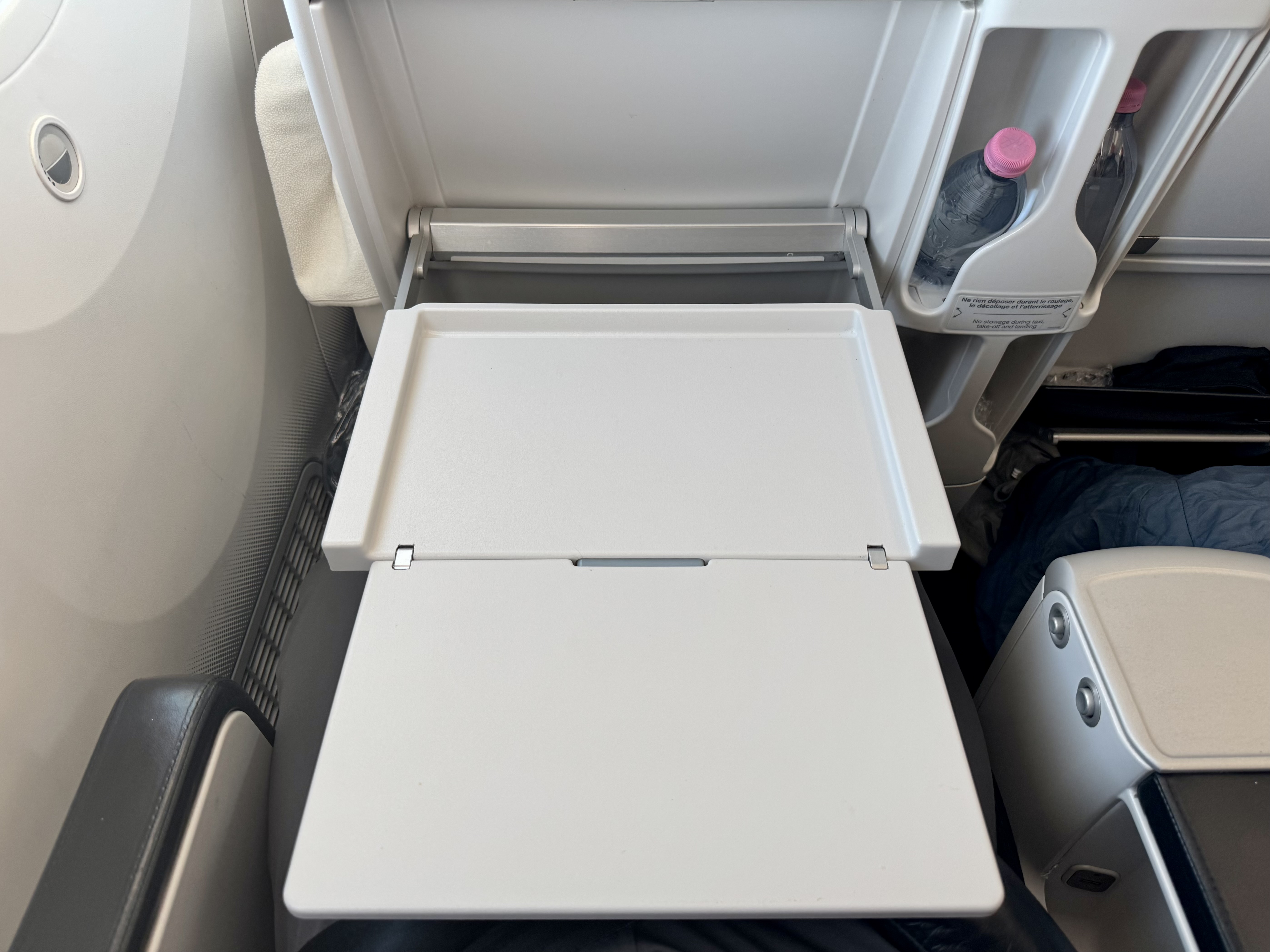 Air France Boeing 789 premium economy seat tray table extended Air France Boeing 789 premium economy seat tray table extended