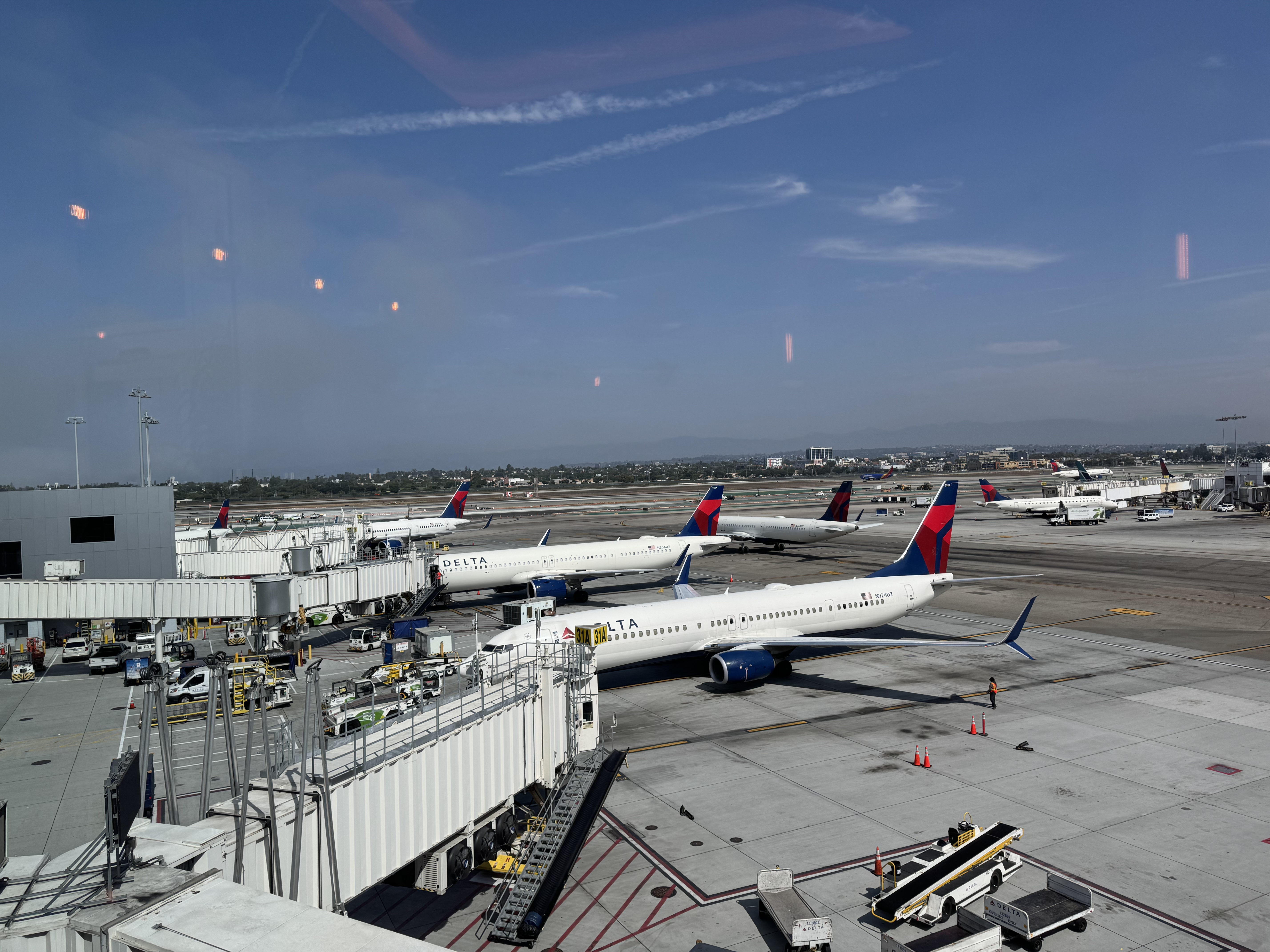 Delta planes parked at LAX gates view from Delta One Lounge