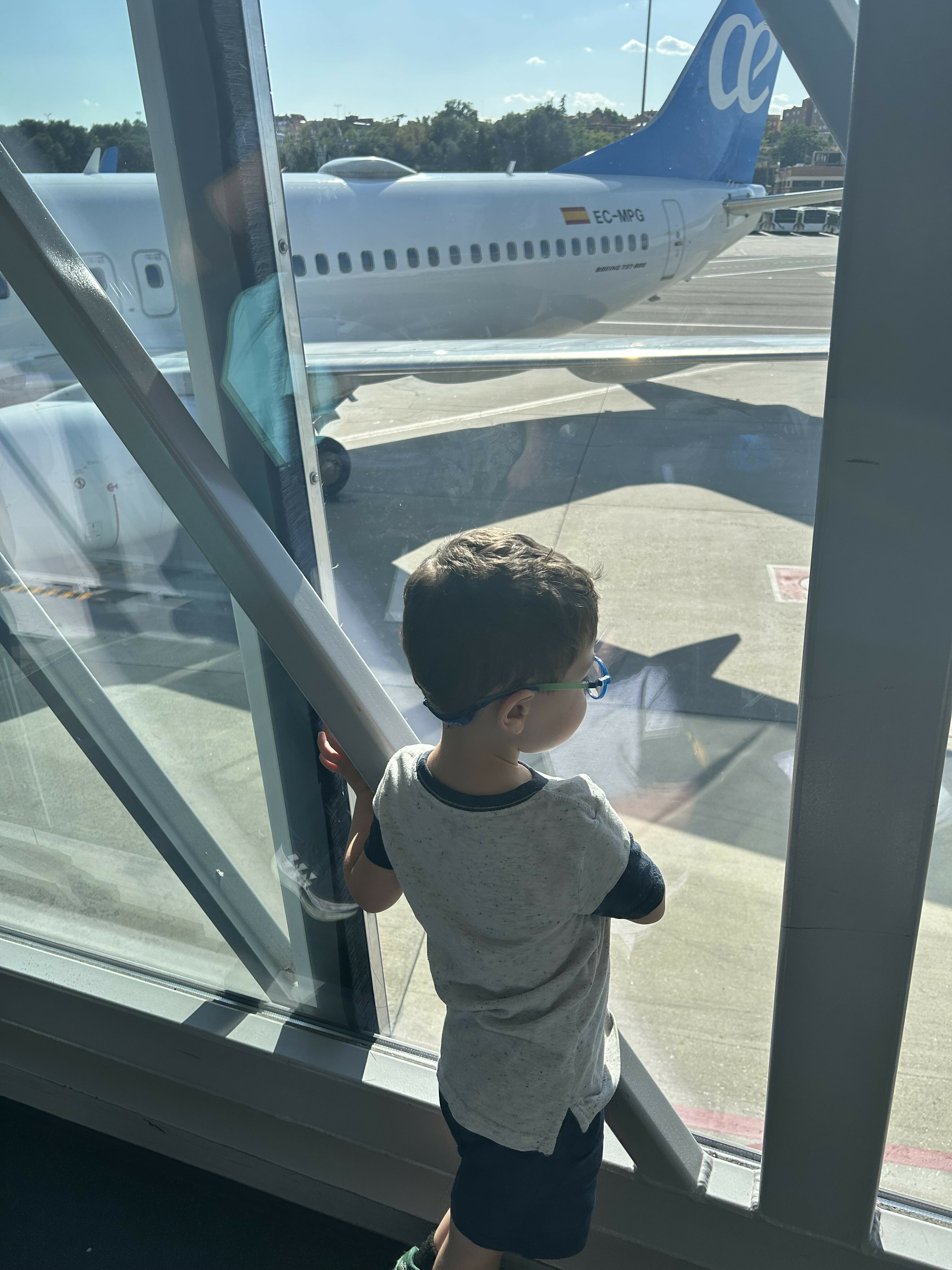 Kid looking at plane Toddler airport