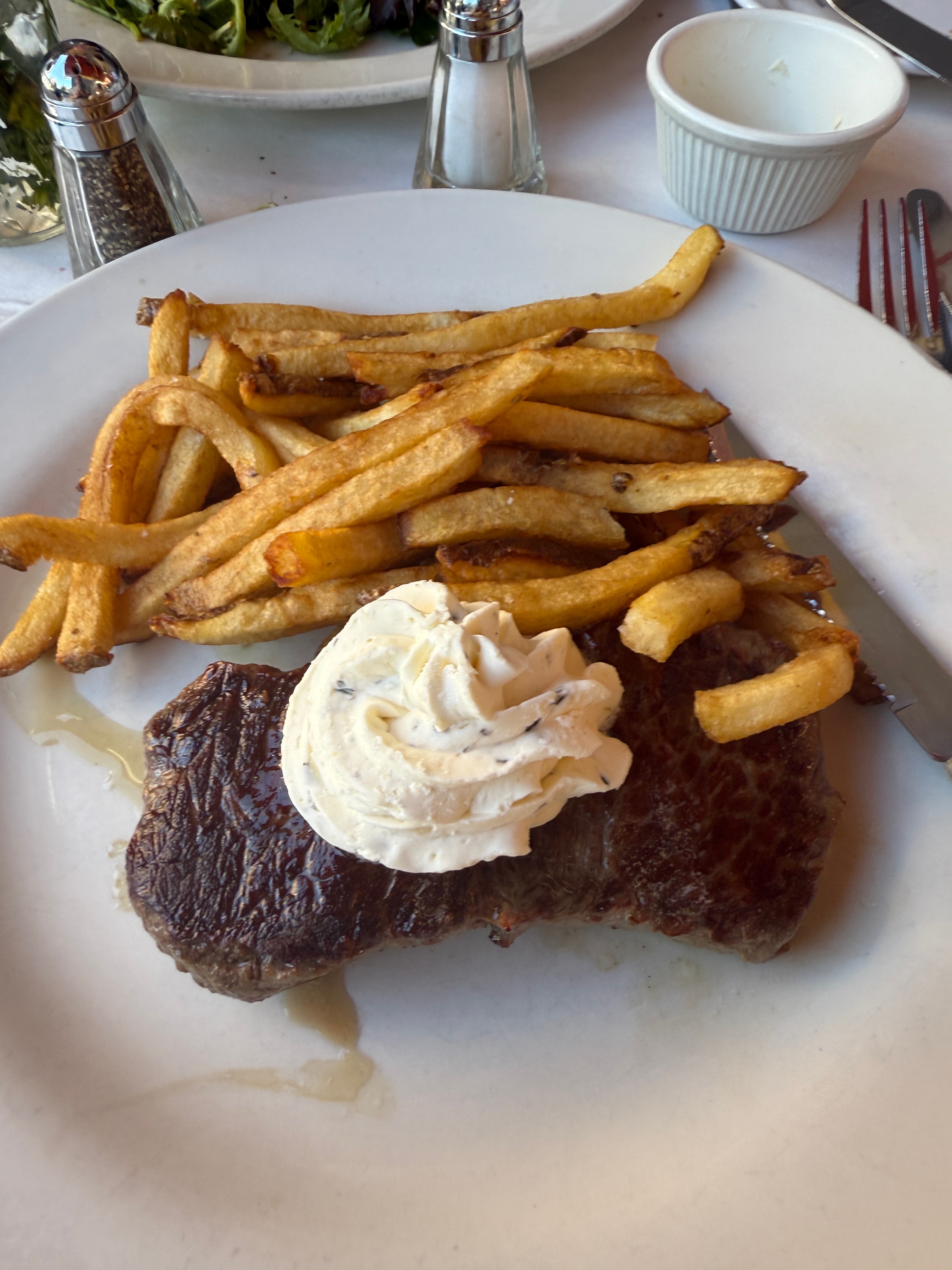 A plate of steak frites on a table at Bistro Les Amis in Manhattan A plate of steak frites on a table at Bistro Les Amis in Manhattan