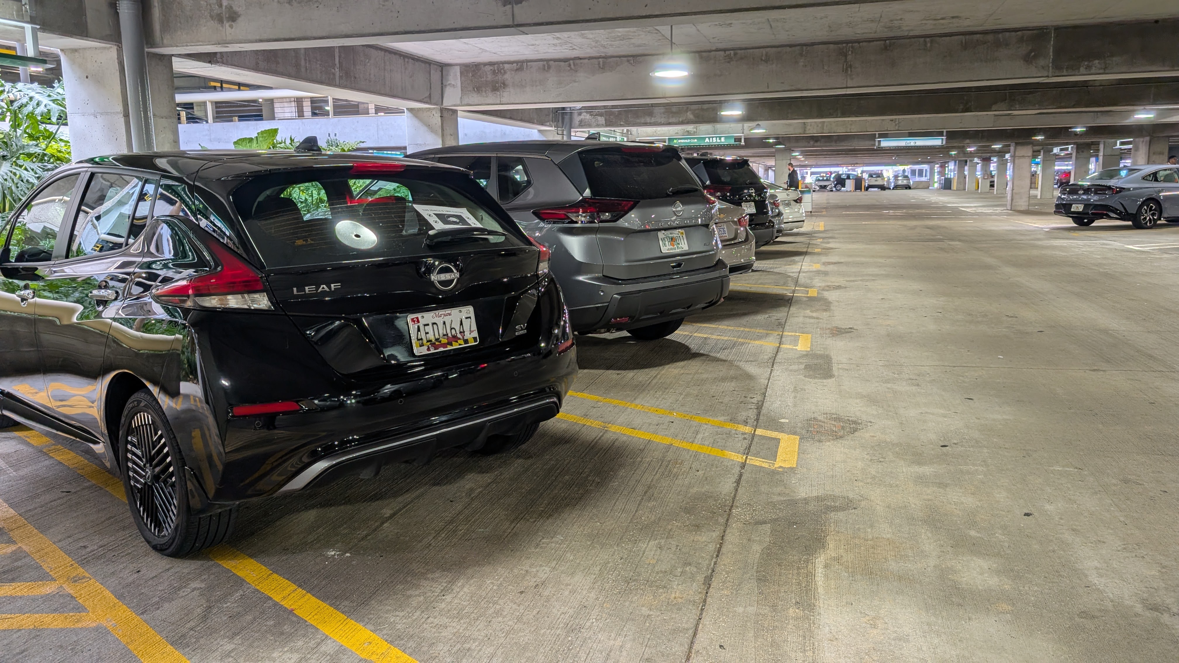 Lady driving car National Car Rental MCO Emerald Aisle