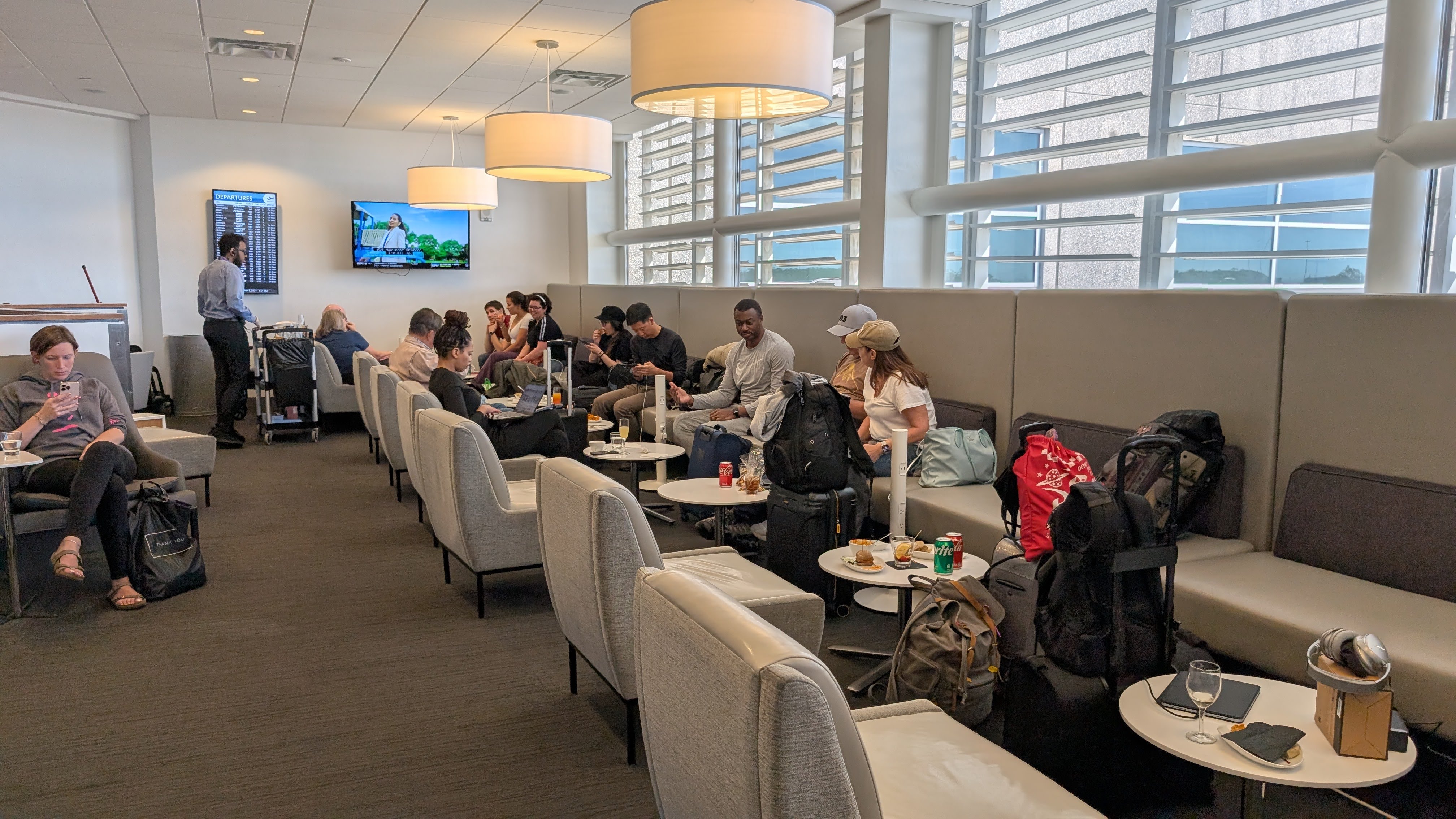 The Club MCO Terminal A booth seating with information screens The Club MCO Terminal A booth seating with information screens