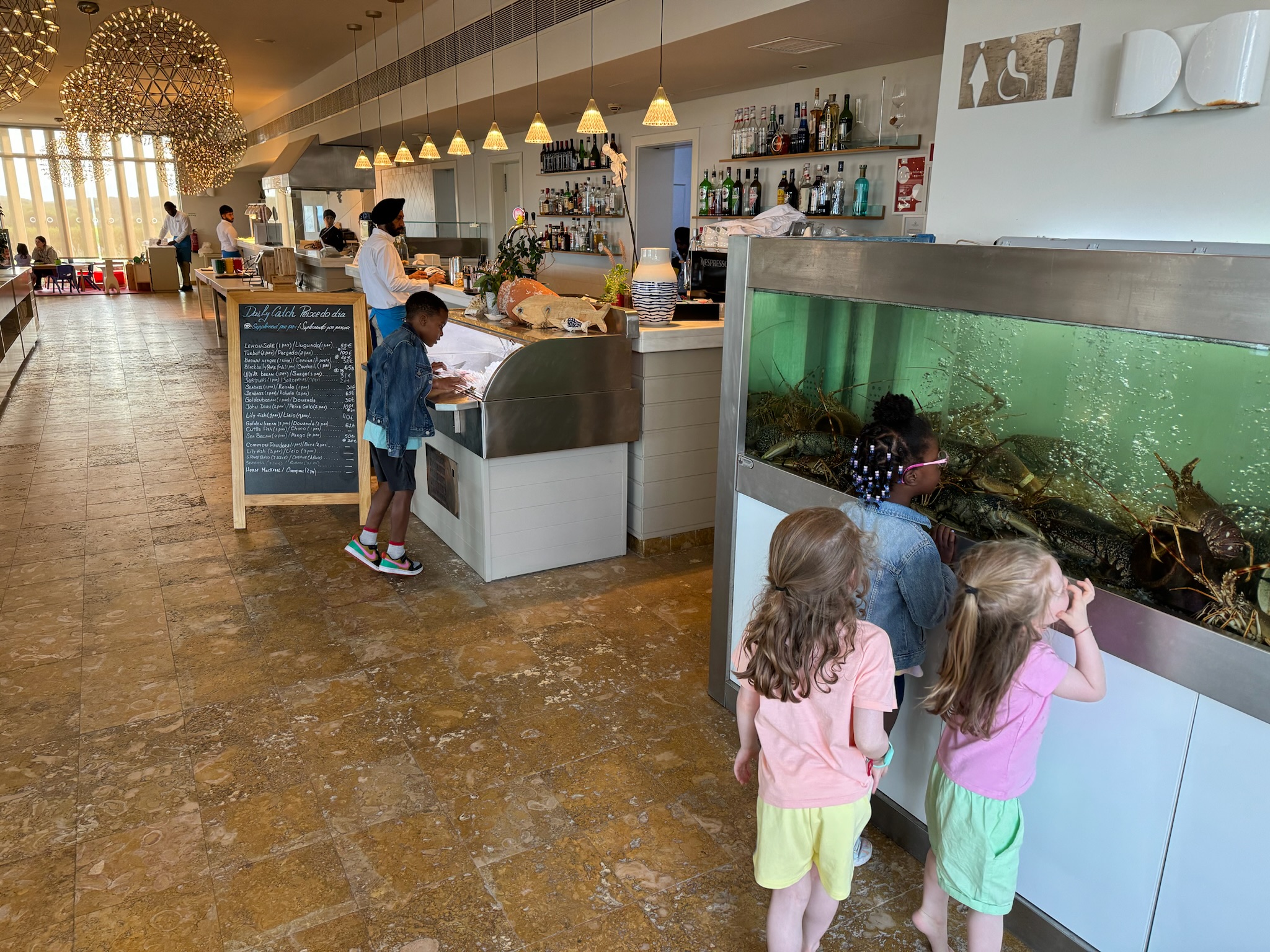 Ashley Onadele kids and others check out fish and lobster Martinhal Sagres Ashley Onadele kids and others check out fish and lobster Martinhal Sagres