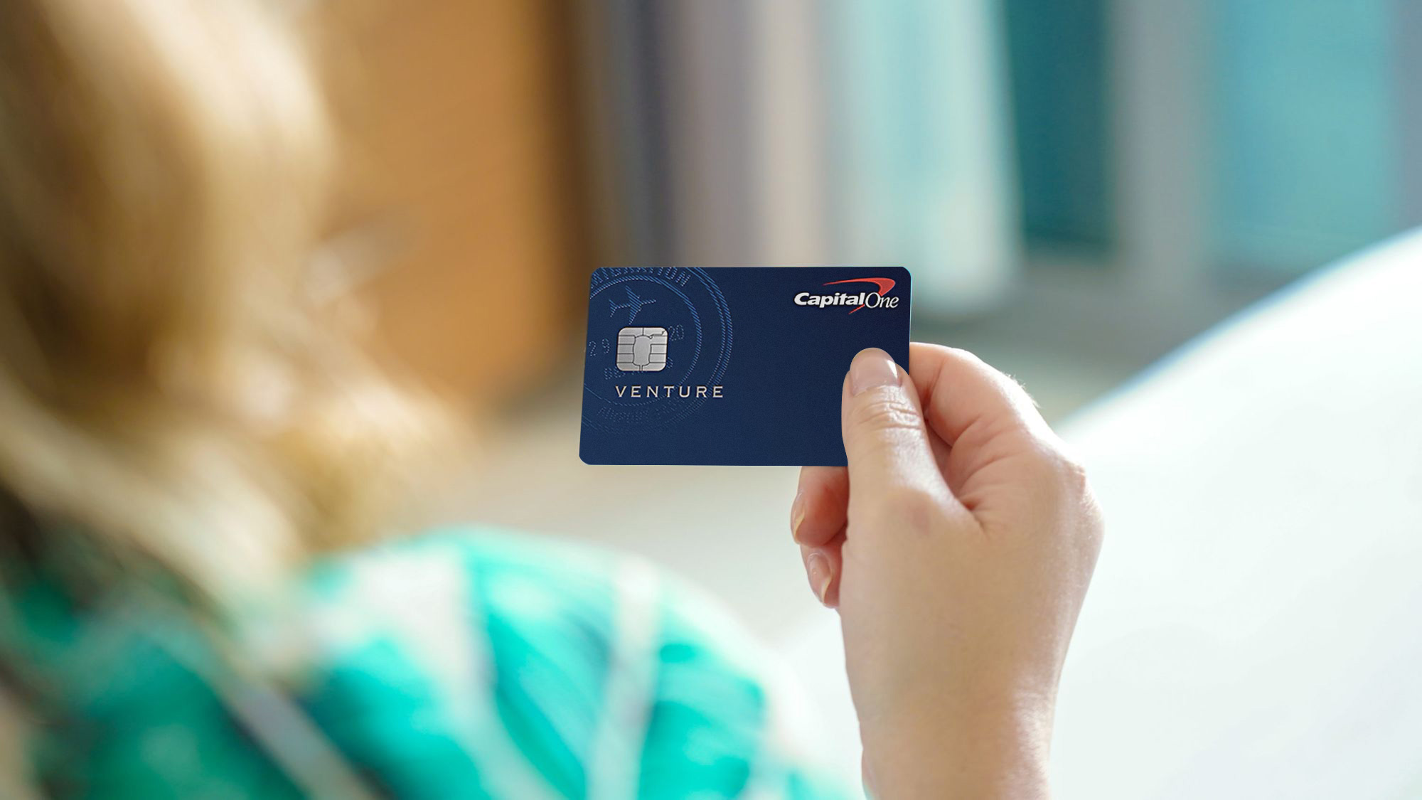 Female hand holding Capital One Venture Card Upgraded Points LLC Female hand holding Capital One Venture Card Upgraded Points LLC