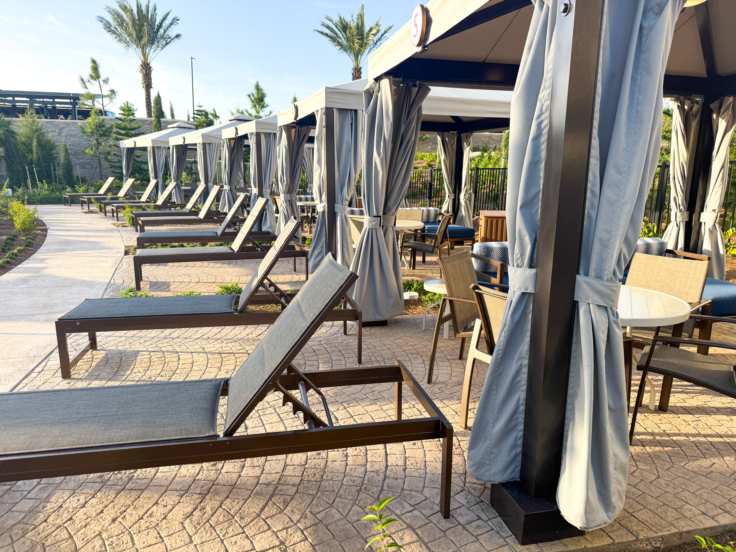 Universal Helios Grand Hotel Loews Hotel Epic Universe pool chairs Universal Helios Grand Hotel Loews Hotel Epic Universe pool chairs