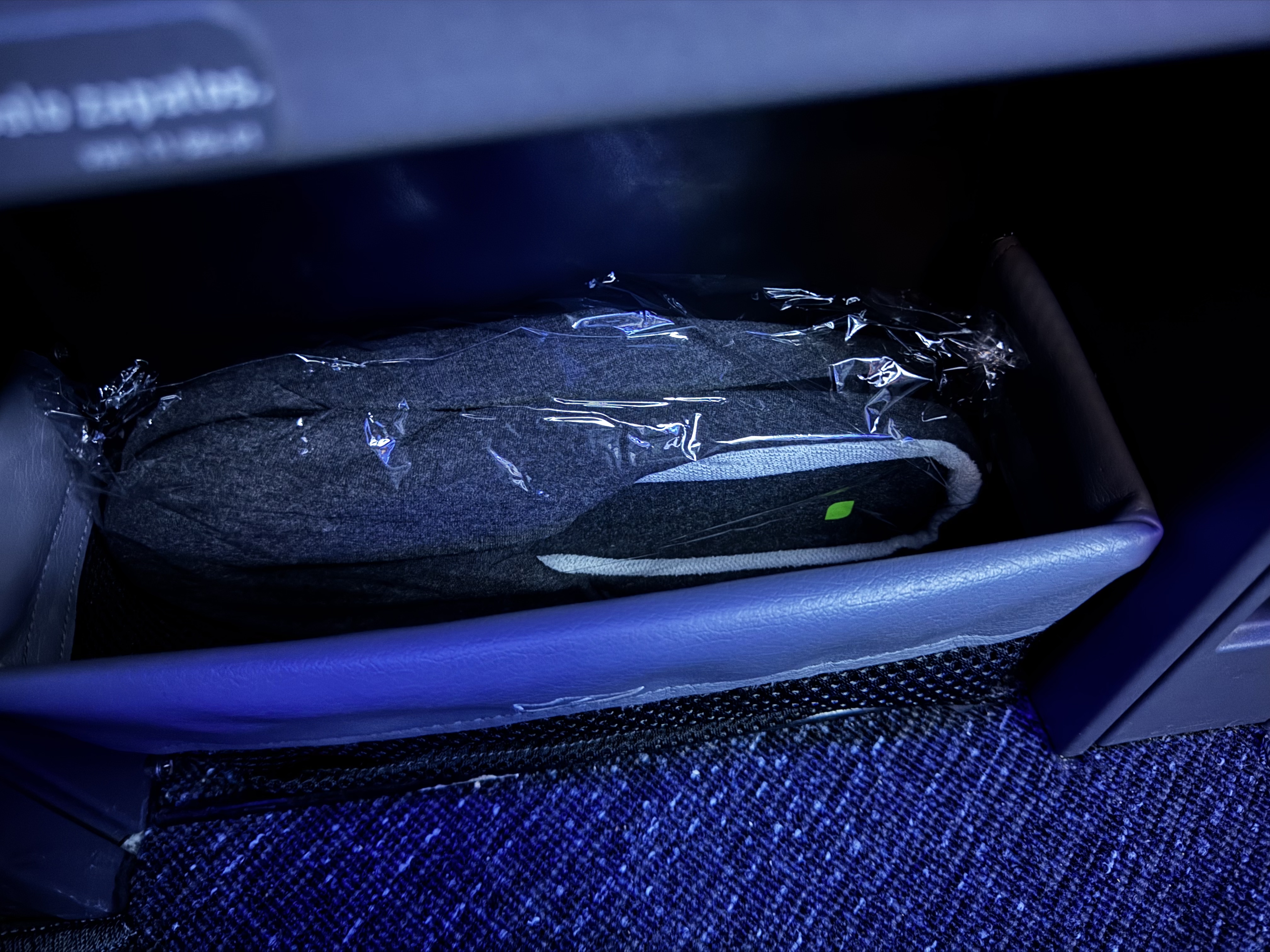 JetBlue Mint A321XLR BOS MAD slippers in bin JetBlue Mint A321XLR BOS MAD slippers in bin