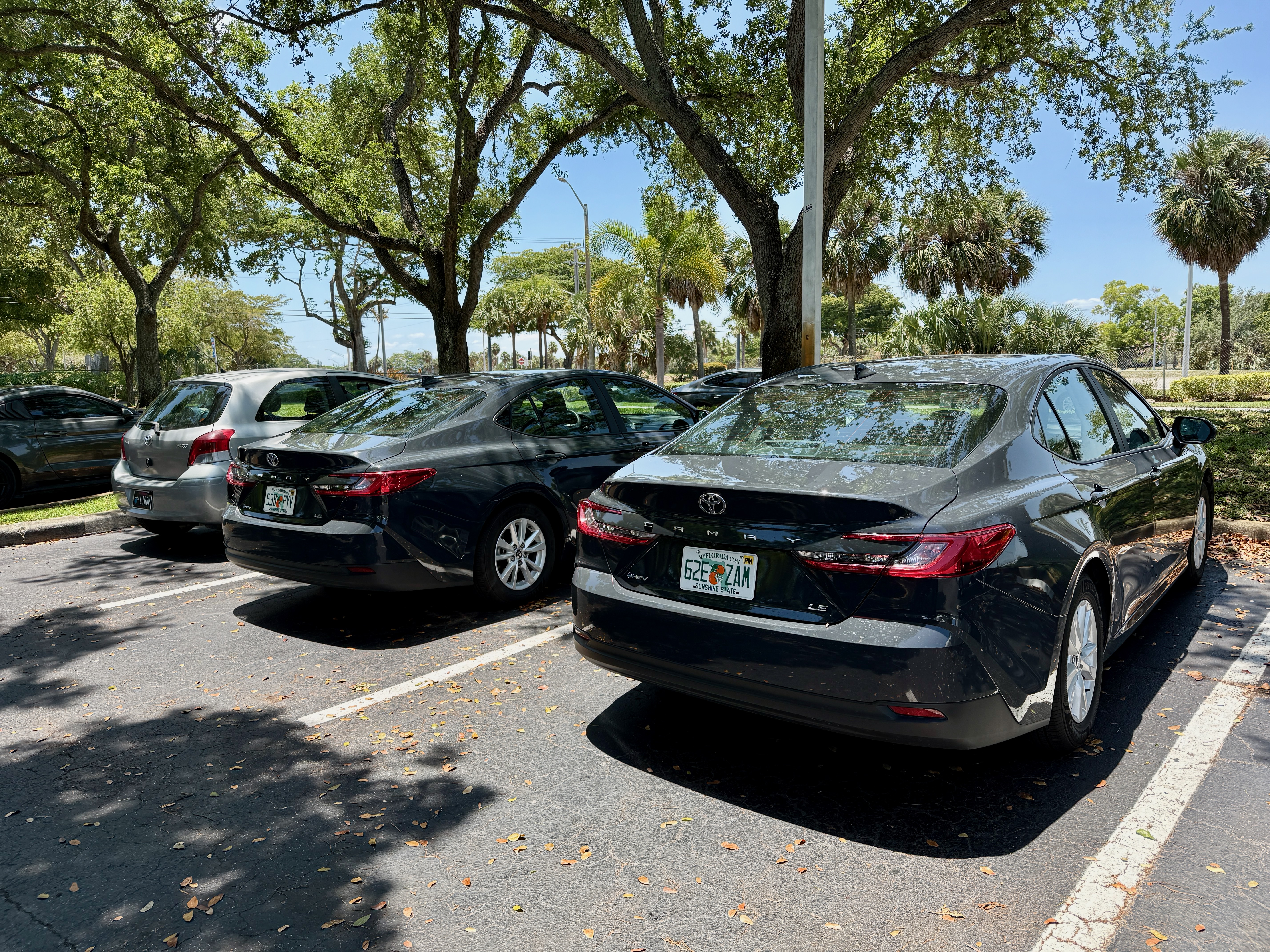 Three cars in a parking lot