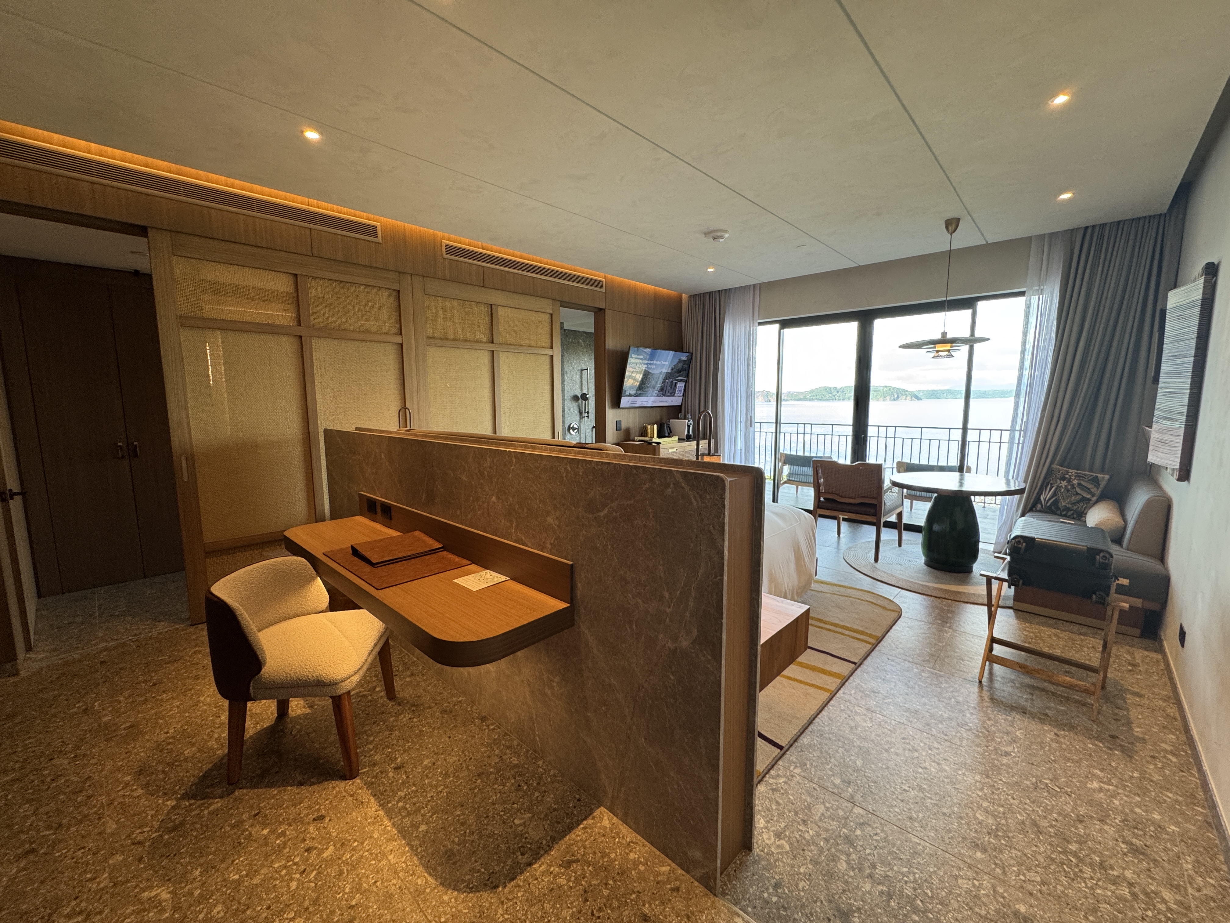 Waldorf Astoria Costa Rica King Suite bedroom desk and bed