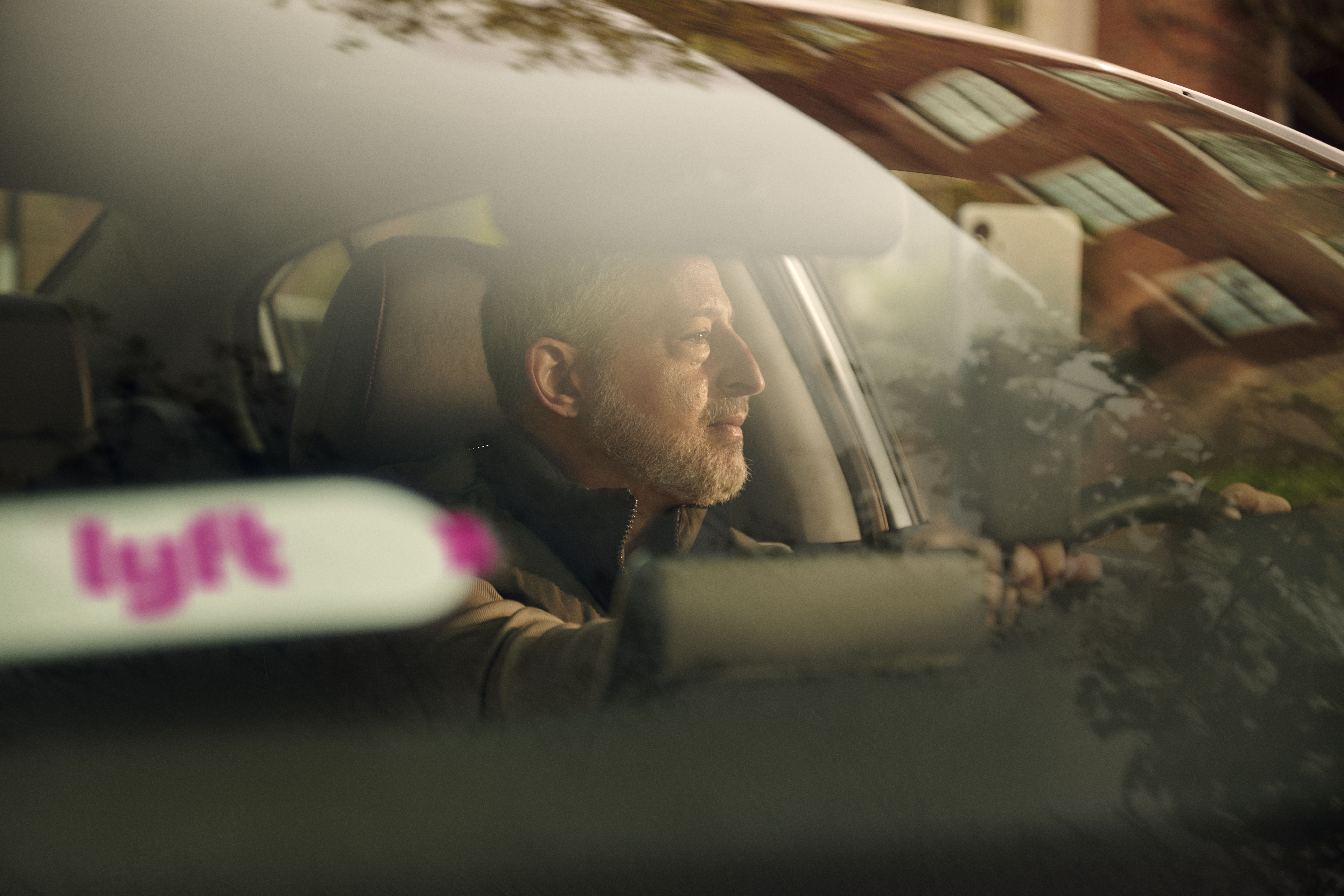 Man driving a Lyft vehicle Man driving a Lyft vehicle